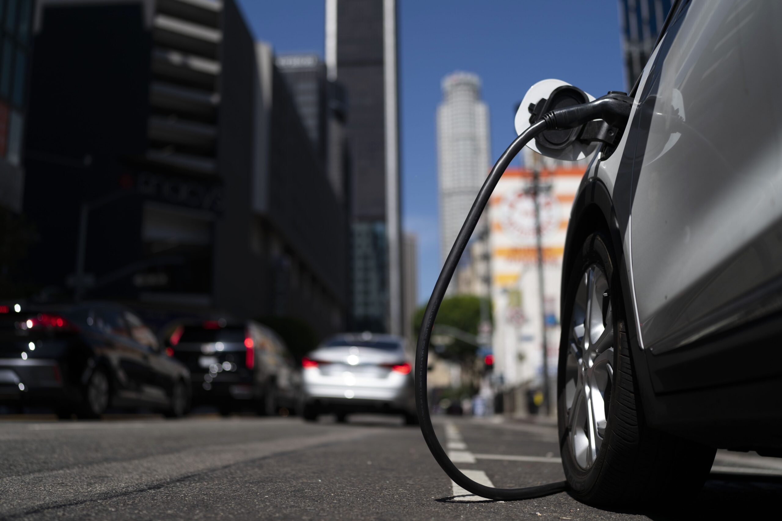 FILE - An electric vehicle is plugged into a charger in Los Angeles, Aug. 25, 2022. Since passage o...