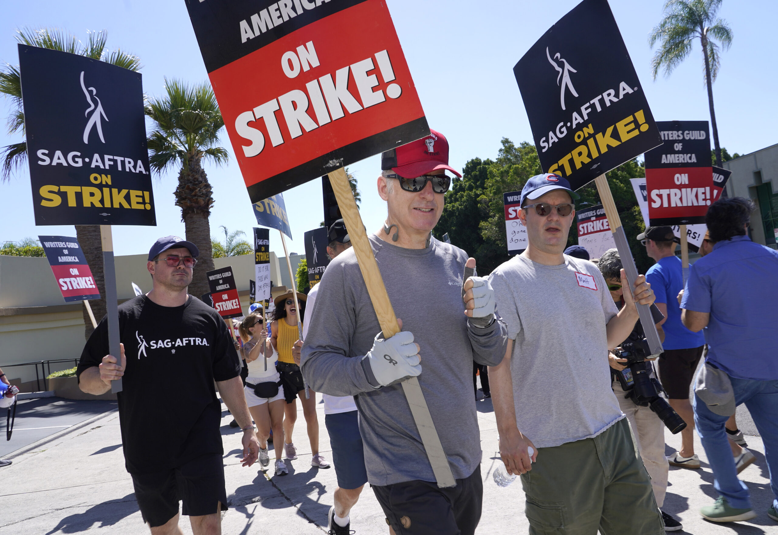 Actor Bob Odenkirk, center, carries a sign on a picket line outside Paramount studios on Wednesday,...