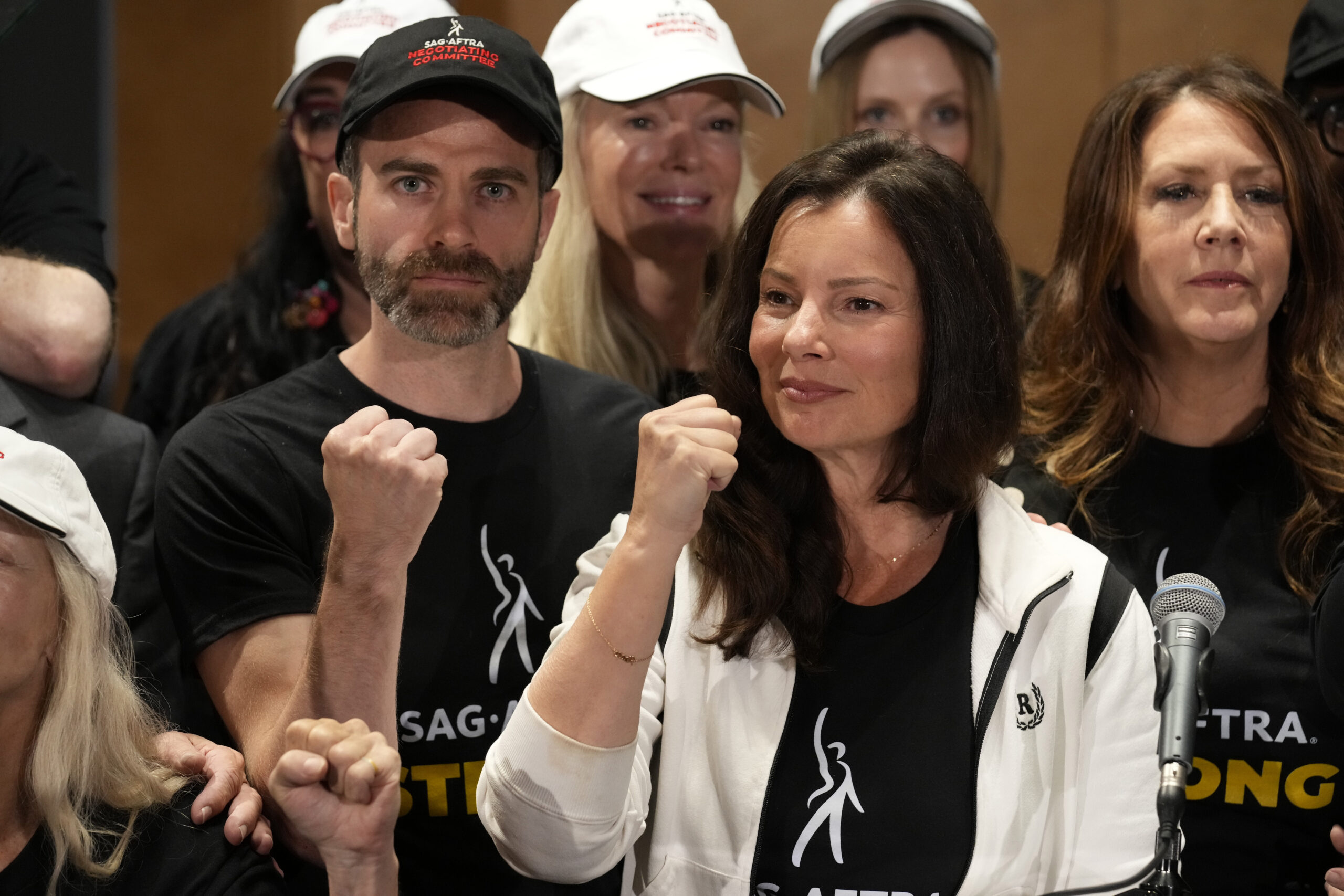 SAG-AFTRA president Fran Drescher, center, Ben Whitehair, left, and Joely Fisher attend a press con...