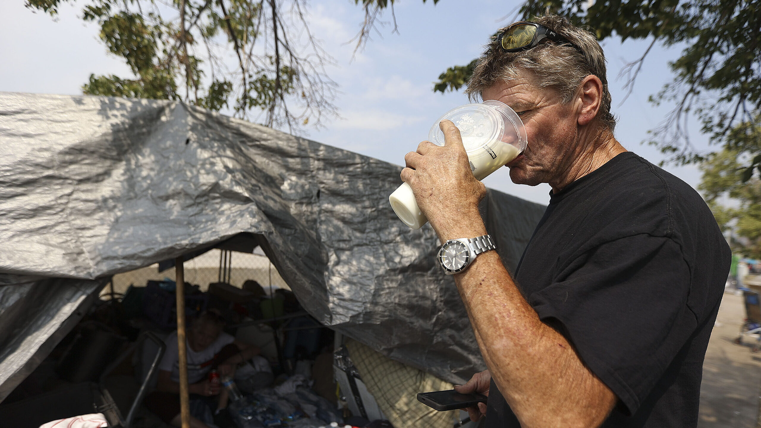 a man drinks iced milk during a heat wave...
