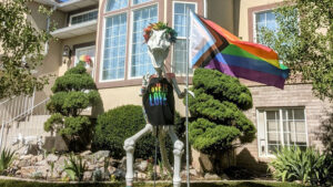LINDON, UTAH – Vandals dismantled part of 9-foot-dinosaur decoration that has dotted a Lindon neighborhood for the past five years.   Homeowner, Sara Dye, said it wasn’t the dinosaur the suspects were going after.   “My pride flag was gone.  The dinosaur was holding a pride flag, and that symbol of acceptance and the dinosaur’s arms were missing.  The rest of the broken dino had been dragged into the middle of the street,” Dye said.  “I was thinking to myself – it finally happened.” Dye decorated the skeleton dinosaur for all occasions.  Denver, as neighbors fondly call the structure, has weathered the deep snow during Christmas, dressed as Cupid for Valentine’s Day, and even acted as a beacon of hope for a little boy named Rex who was fighting cancer, a few houses down.  And in June, Dye gave Denver a rainbow vibe.  “I am very excited about pride,” Dye said. “It was a large part of my life that I couldn’t talk about when I was younger, and now living in a very Mormon neighborhood – we do try to be very respectful.” After investigating, officers with the Lindon City Police Department found pieces of Denver and the pride flag near the Murdock Canal Trail. “It’s still an open investigation. We have officers canvassing the area, near the canal, searching for evidence,” Lindon City Police Chief Mike Brower said.