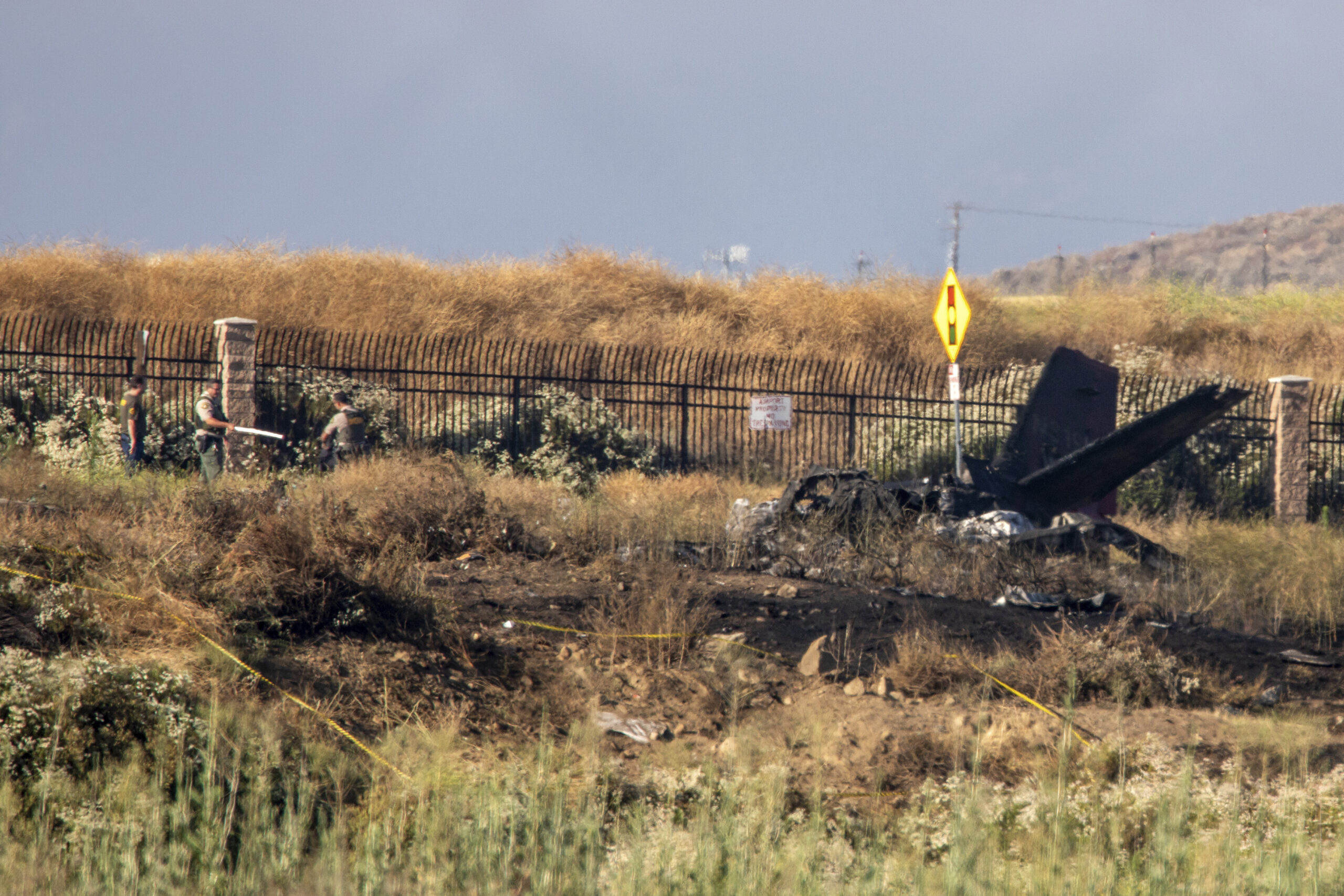 Charred remains of a Cessna lie near the landing approach at French Valley Airport, in Murrieta, Ca...
