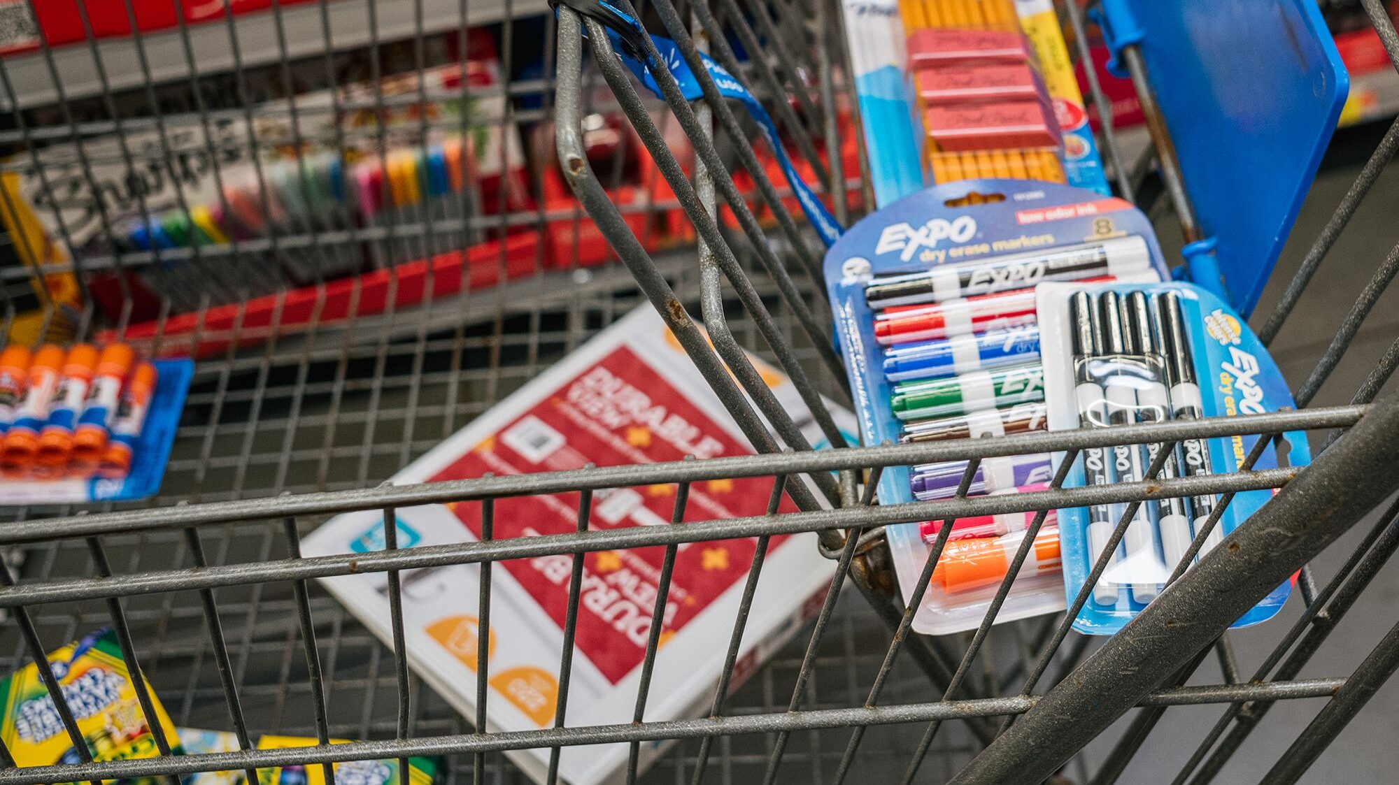 a grocery cart with toothpaste and toothbrushes in it...
