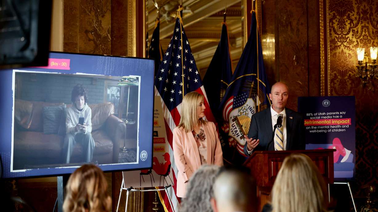 Aimee Winder Newton, Director of the Office of Families, left, and Utah Governor Spencer Cox are pi...