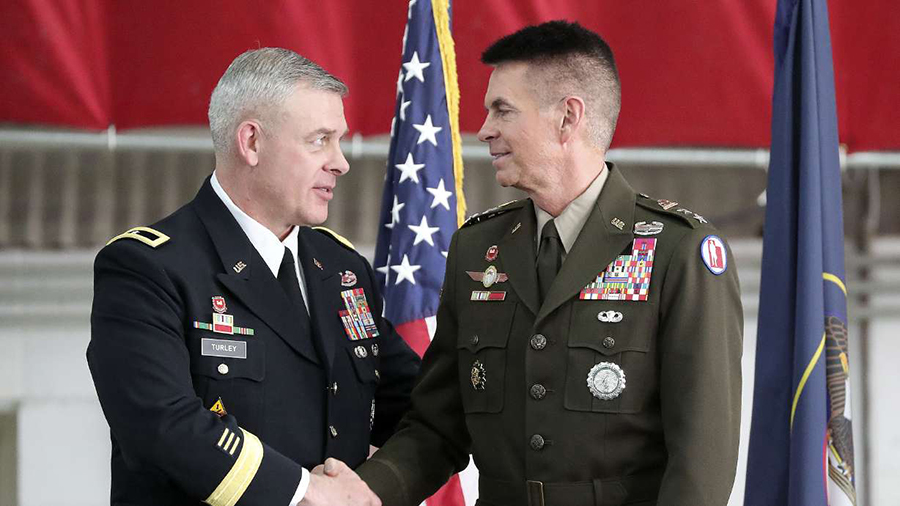 Utah National Guard Brig. Gen. Michael Turley (left) shakes hands with Maj. Gen. Jeff Burton after ...