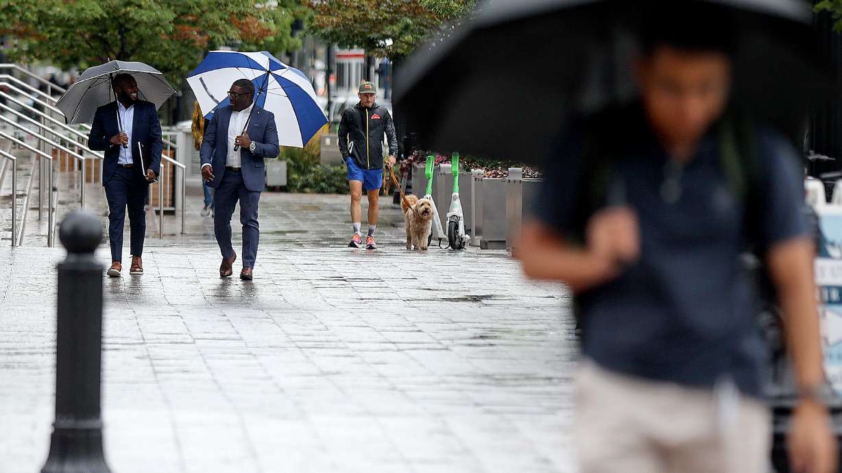 People walk in the rain in downtown Salt Lake City on Tuesday. More rain is in Utah's forecast Thur...