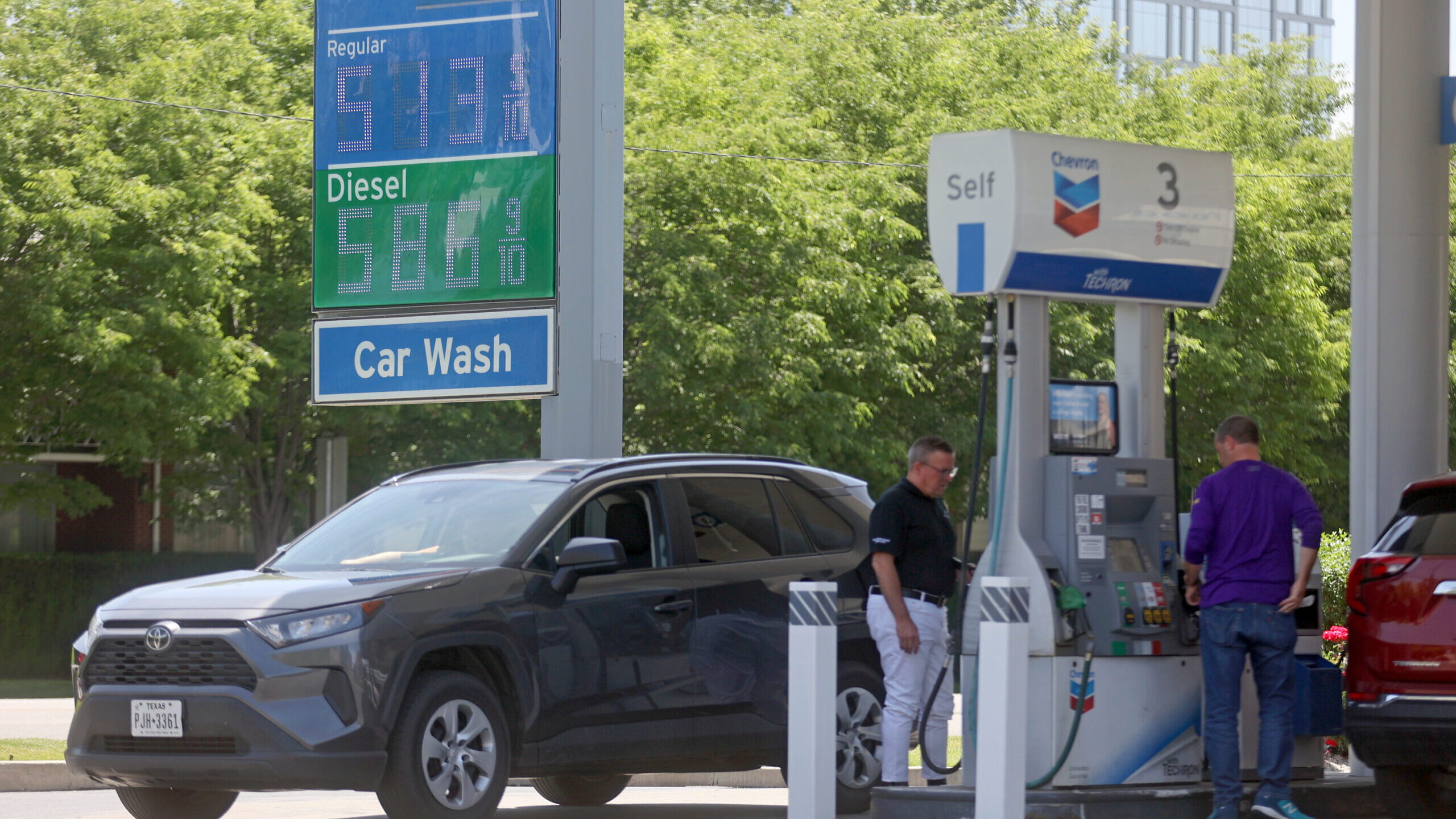 People pump gas as prices rose to more than $5 a gallon at a Chevron station in Salt Lake City on T...