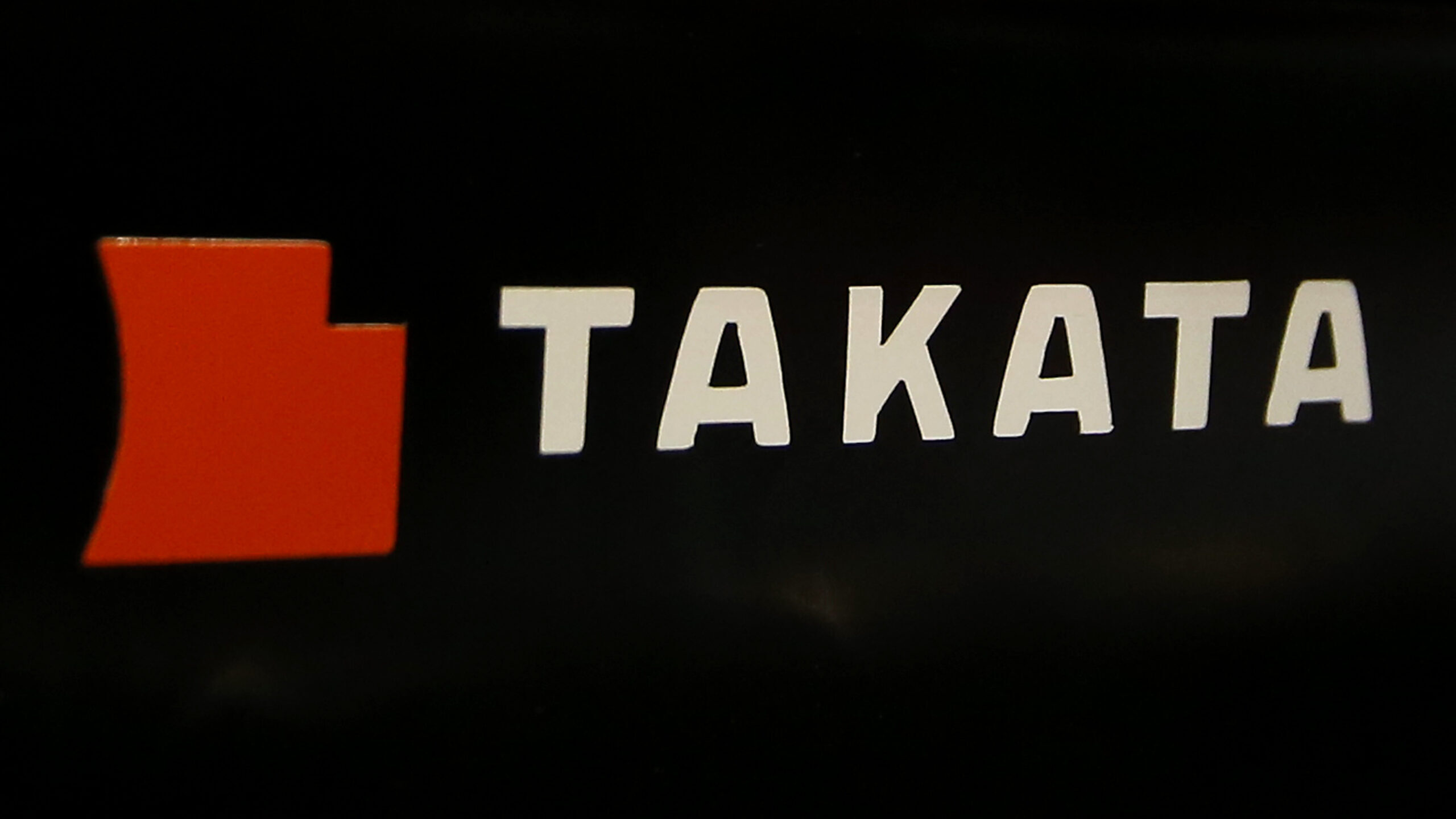 FILE - The logo of Takata Corp. is displayed at an auto supply shop in Tokyo, July 6, 2016. In a do...