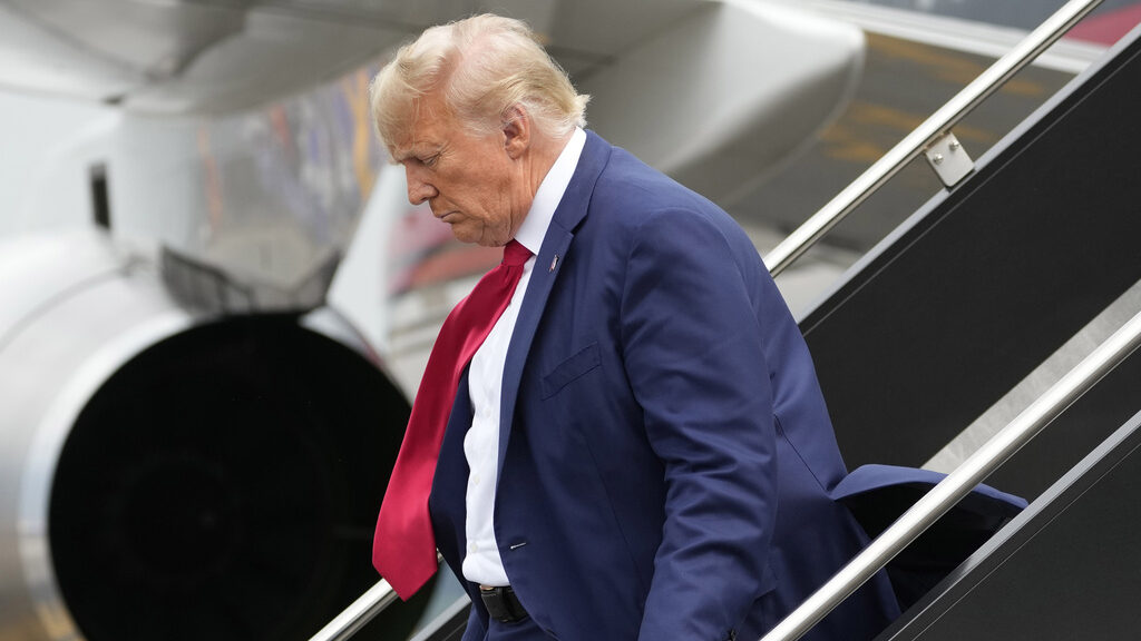Former President Donald Trump arrives at Ronald Reagan Washington National Airport, Thursday, Aug. ...