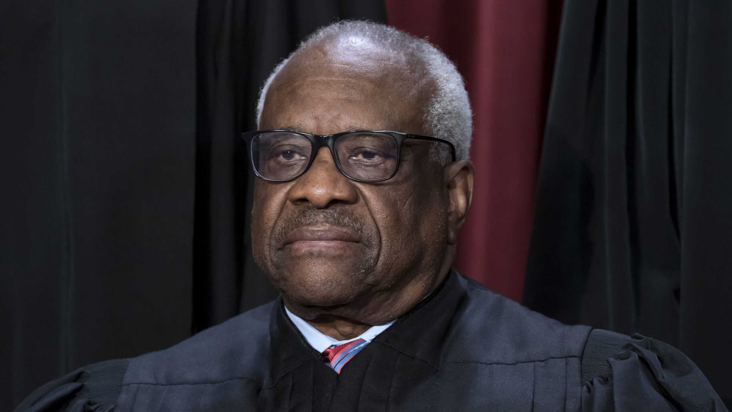 FILE - Associate Justice Clarence Thomas joins other members of the Supreme Court as they pose for ...