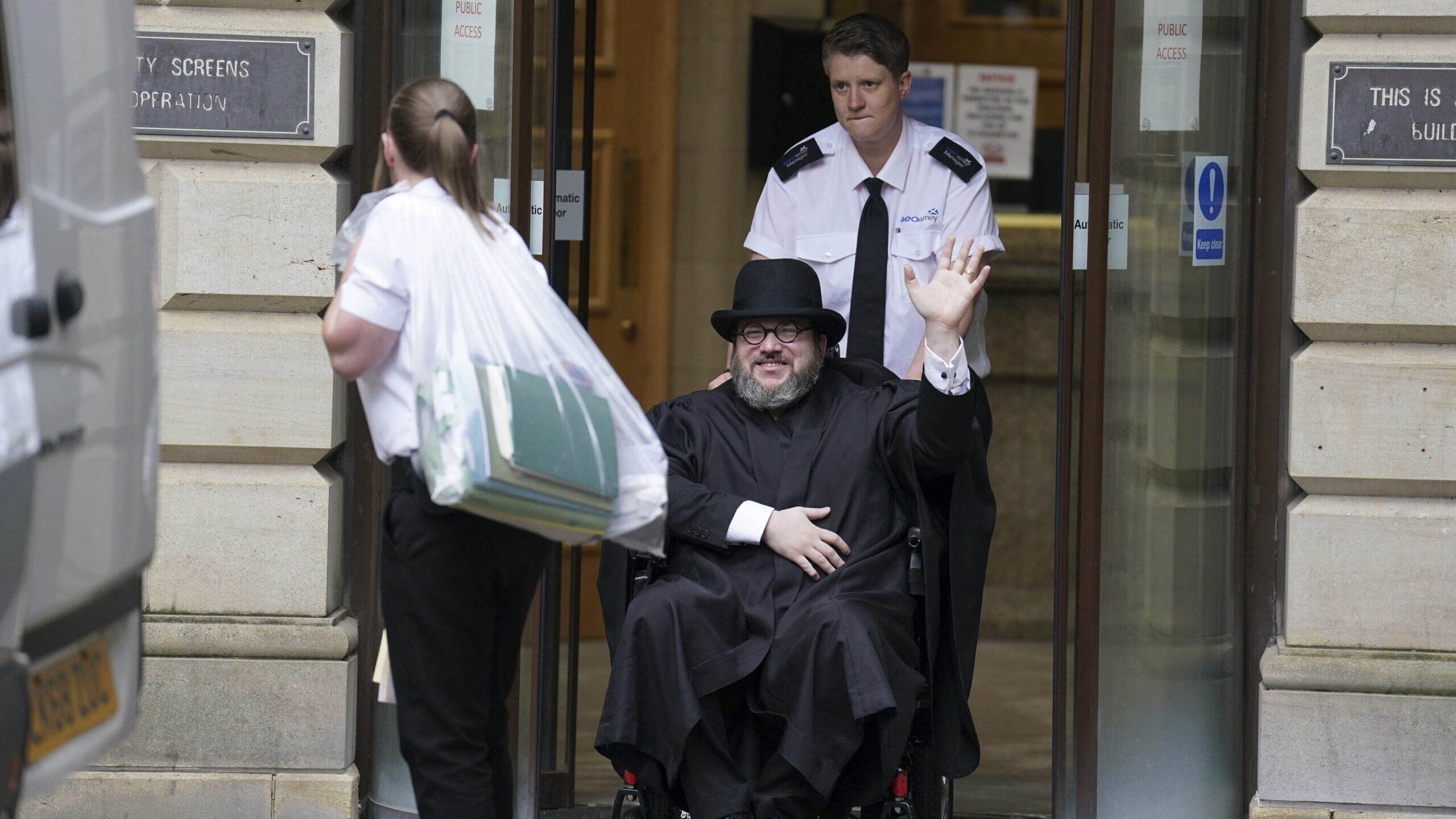 Nicholas Rossi from he U.S. waves as he leaves the Edinburgh Sheriff and Justice of the Peace Court...