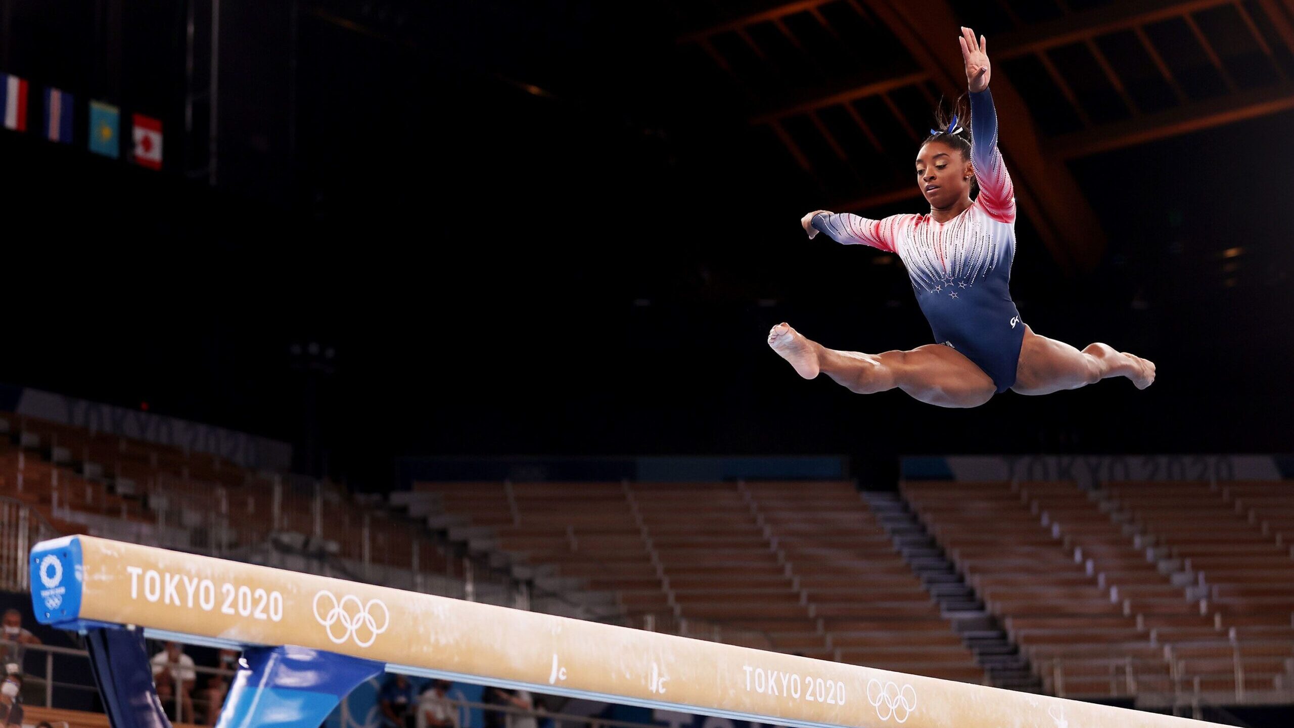 Image of gymnast Simone Biles on the balance beam at the Tokyo Olympic Games. Two years ago, Biles ...