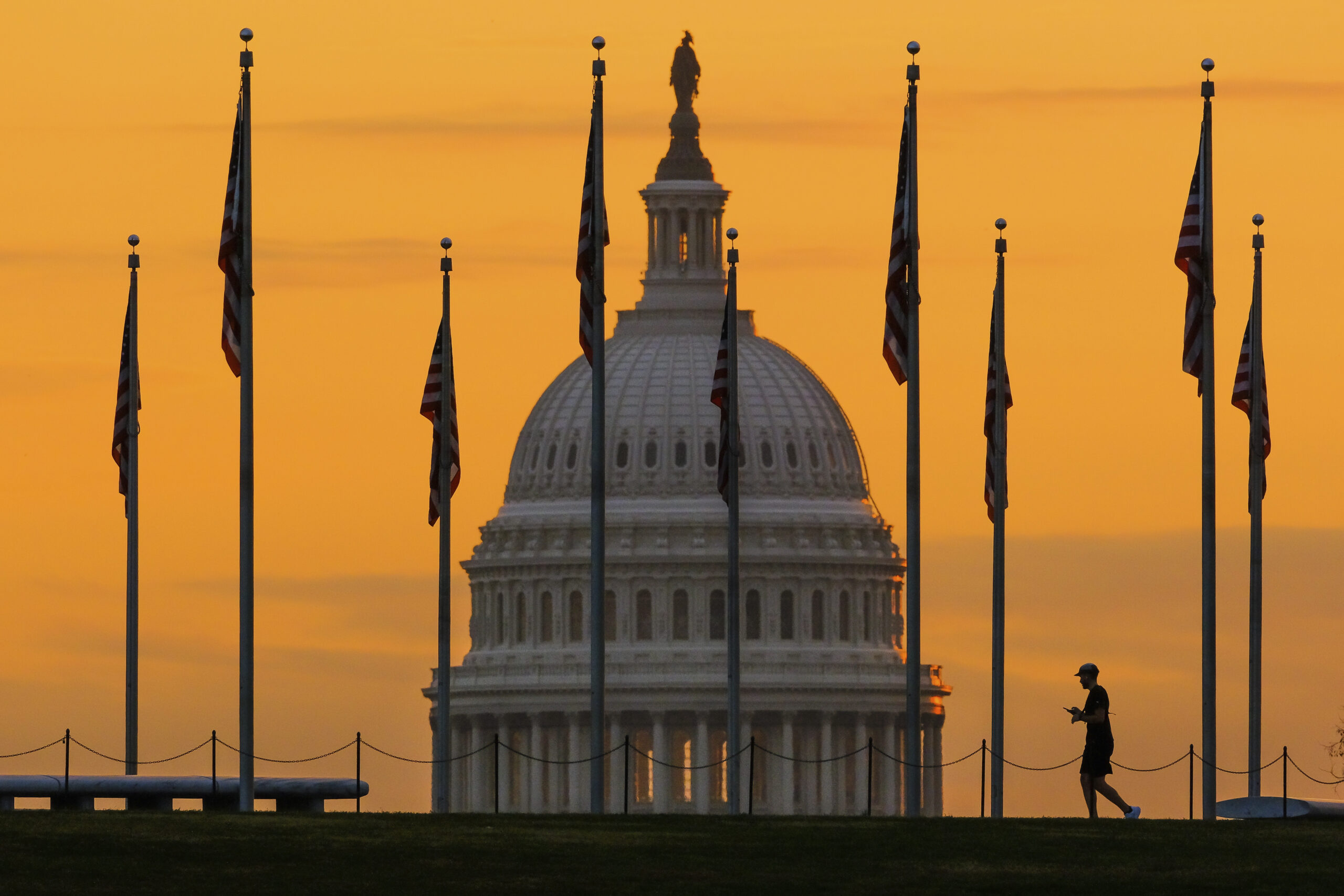 FILE - The U.S. Capitol Building looms behind flags on the National Mall in Washington Nov. 7, 2022...
