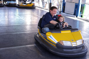 DES MOINES, IOWA - AUGUST 12: Republican U.S. presidential candidate and Florida Governor Ron DeSantis rides in a bumper car with his daughter Madison at the Iowa State Fair on August 12, 2023 in Des Moines, Iowa. Republican and Democratic presidential hopefuls, including Florida Governor Ron DeSantis and former U.S. President Donald Trump, are visiting the fair to greet fairgoers prior to states to hold caucuses in 2024. (Photo by Alex Wong/Getty Images)