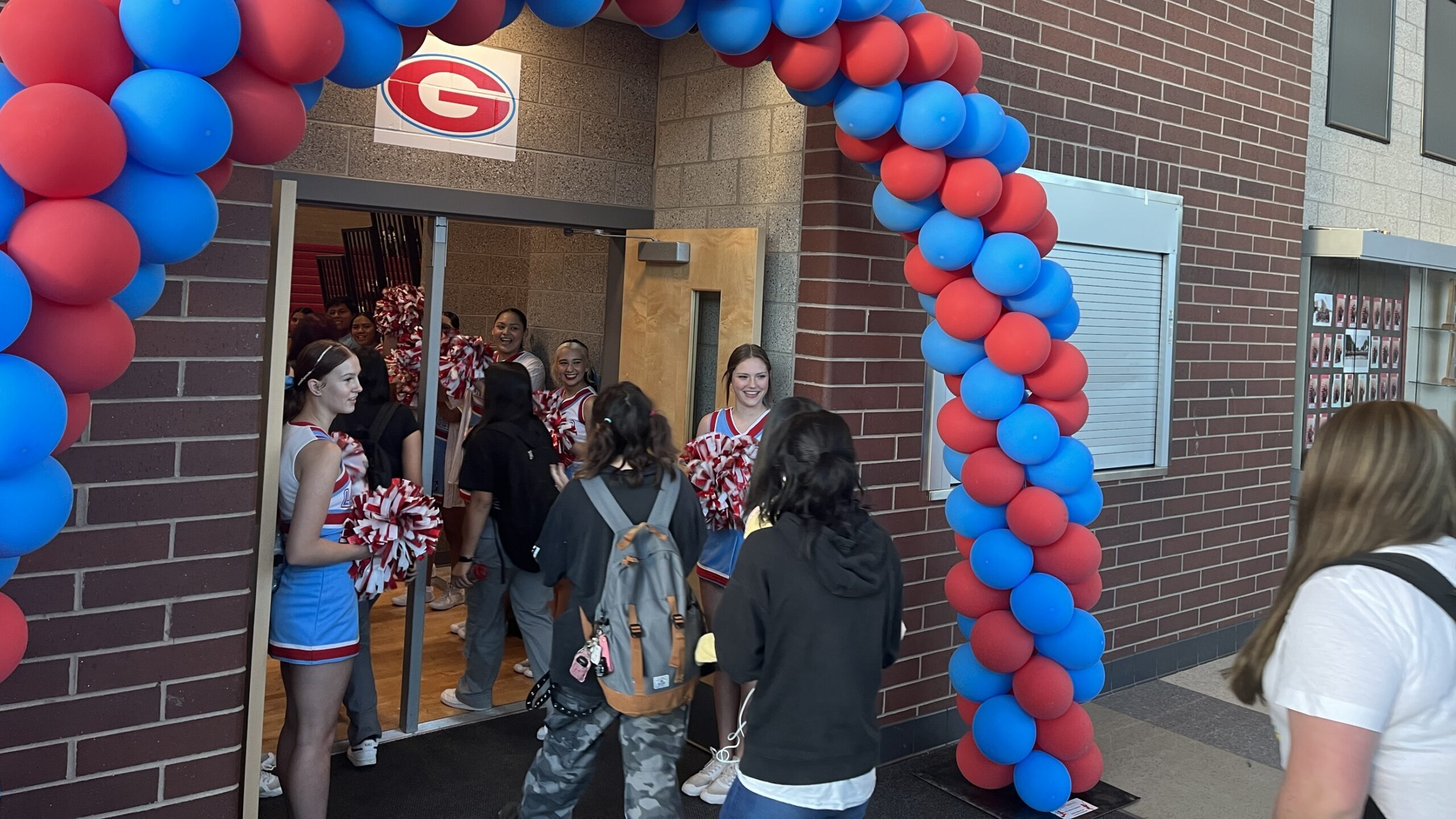 cheerleaders welcome students for first day back to school...