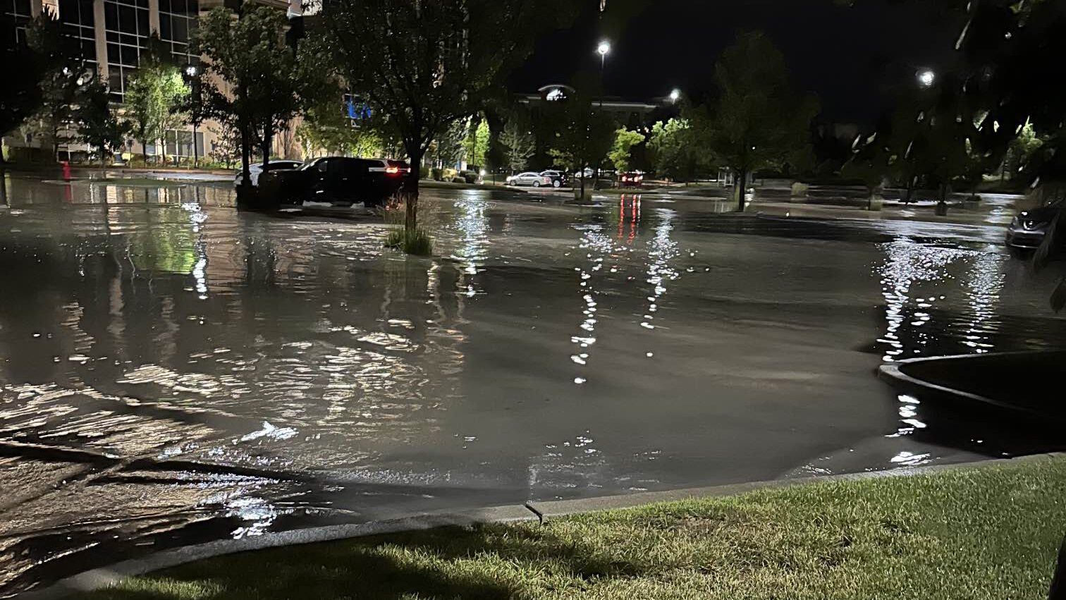 A parking lot by a tsunami sushi restaurant in South Jordan is flooded by water....