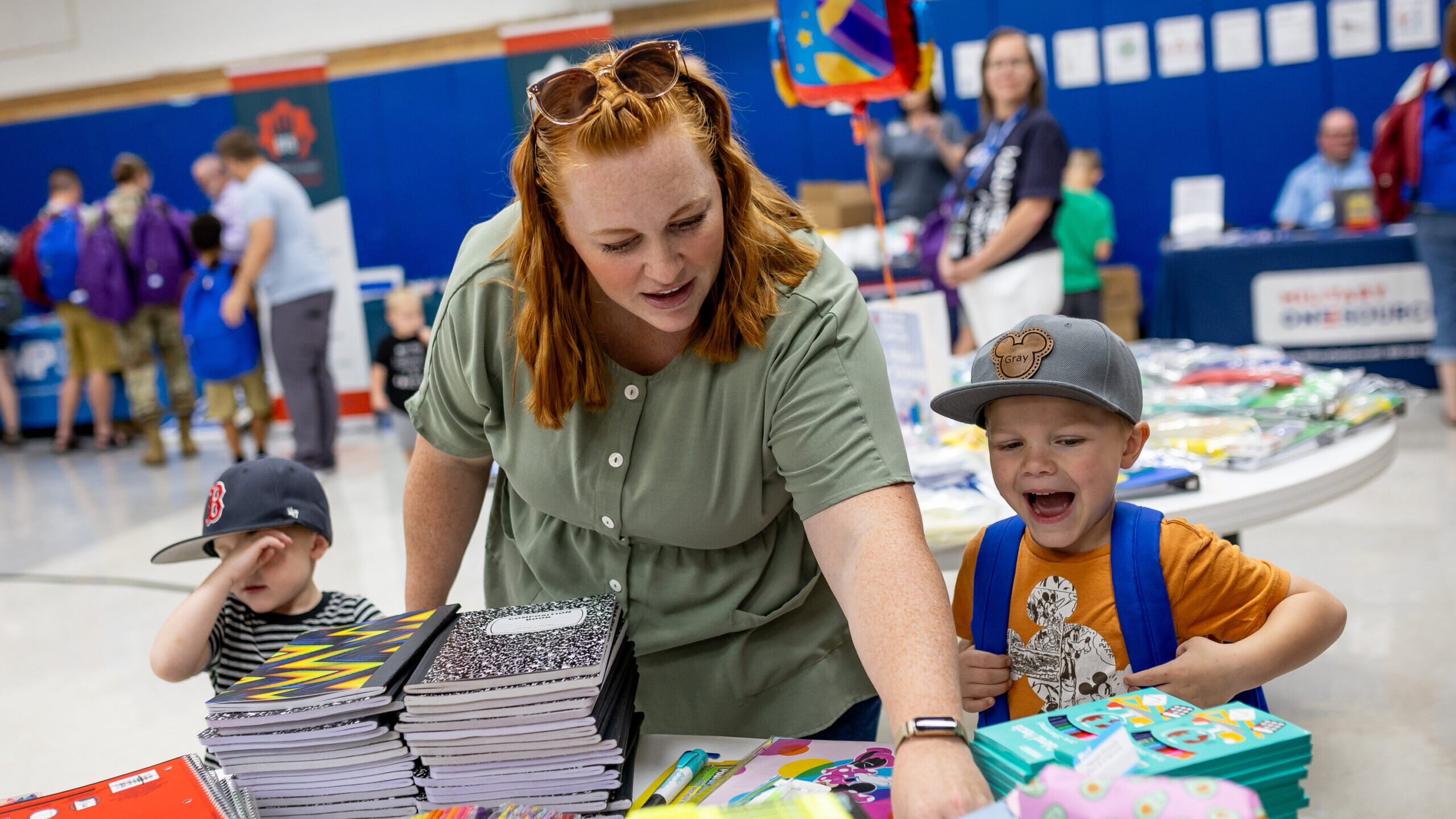 Macey Walters, whose husband is in the Air Force, collects free school supplies with her children, ...