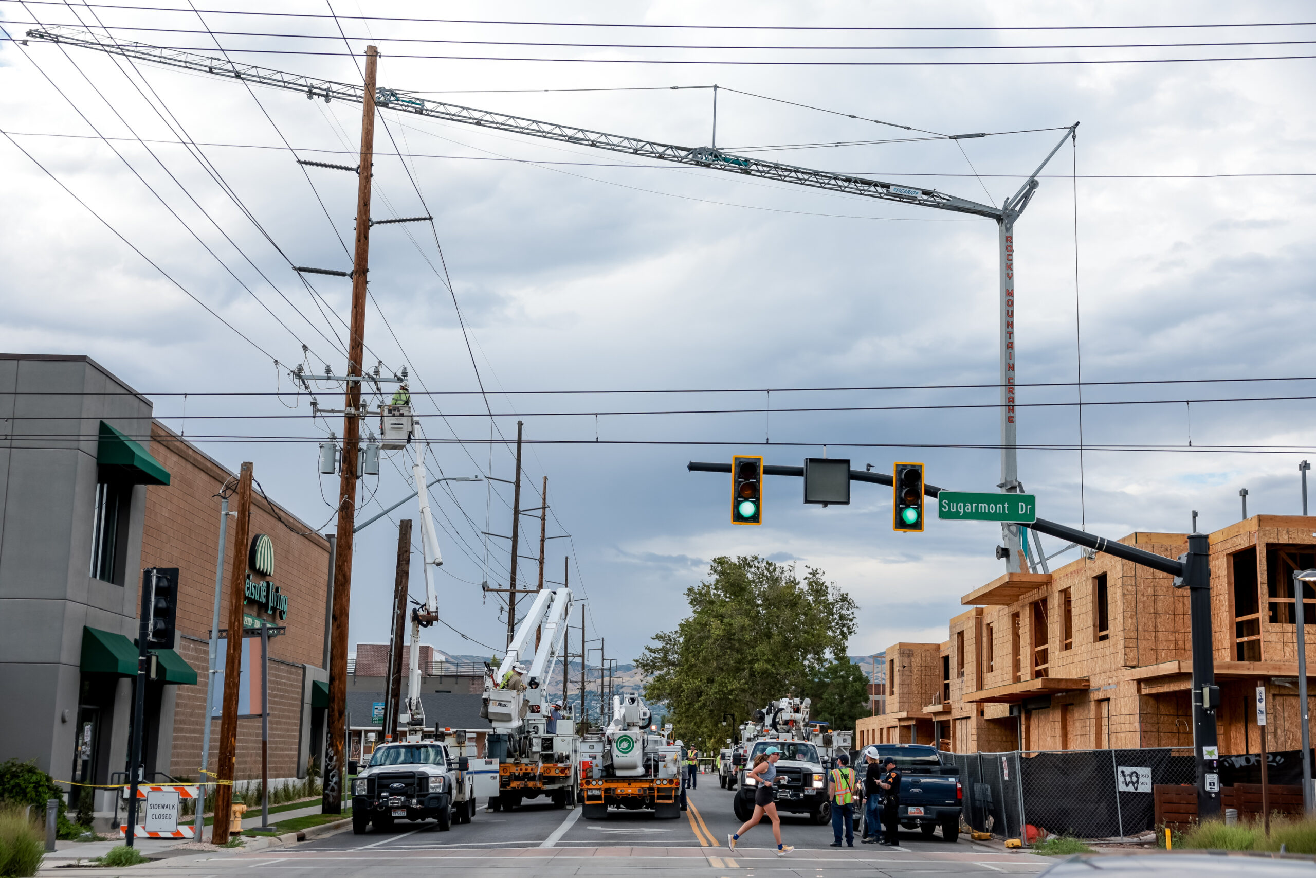 Rocky Mountain Power and emergency crews respond after a construction crane hit power lines causing...