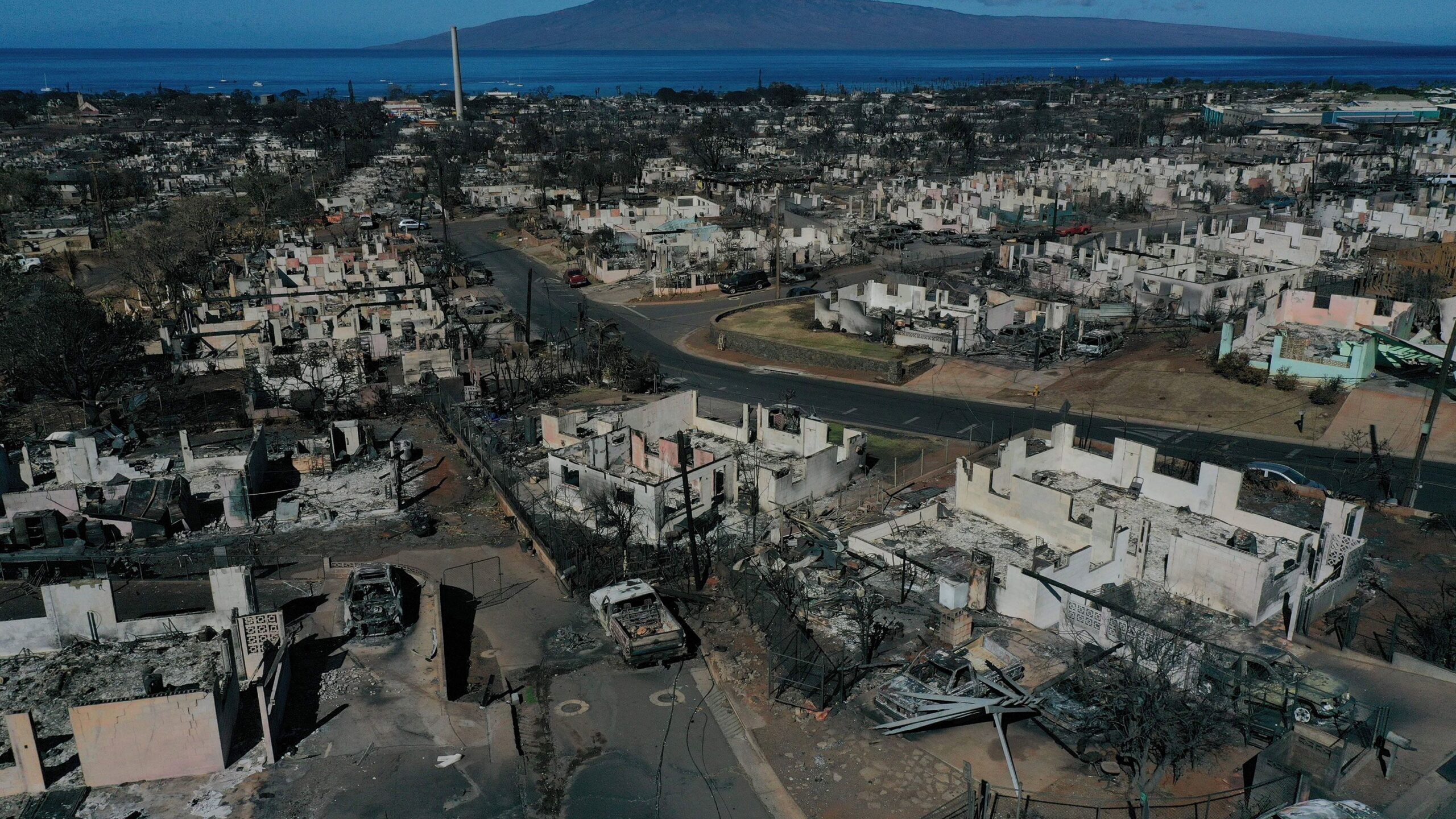 An aerial image shows destroyed homes and vehicles on August 17 after a wind-driven wildfire burned...