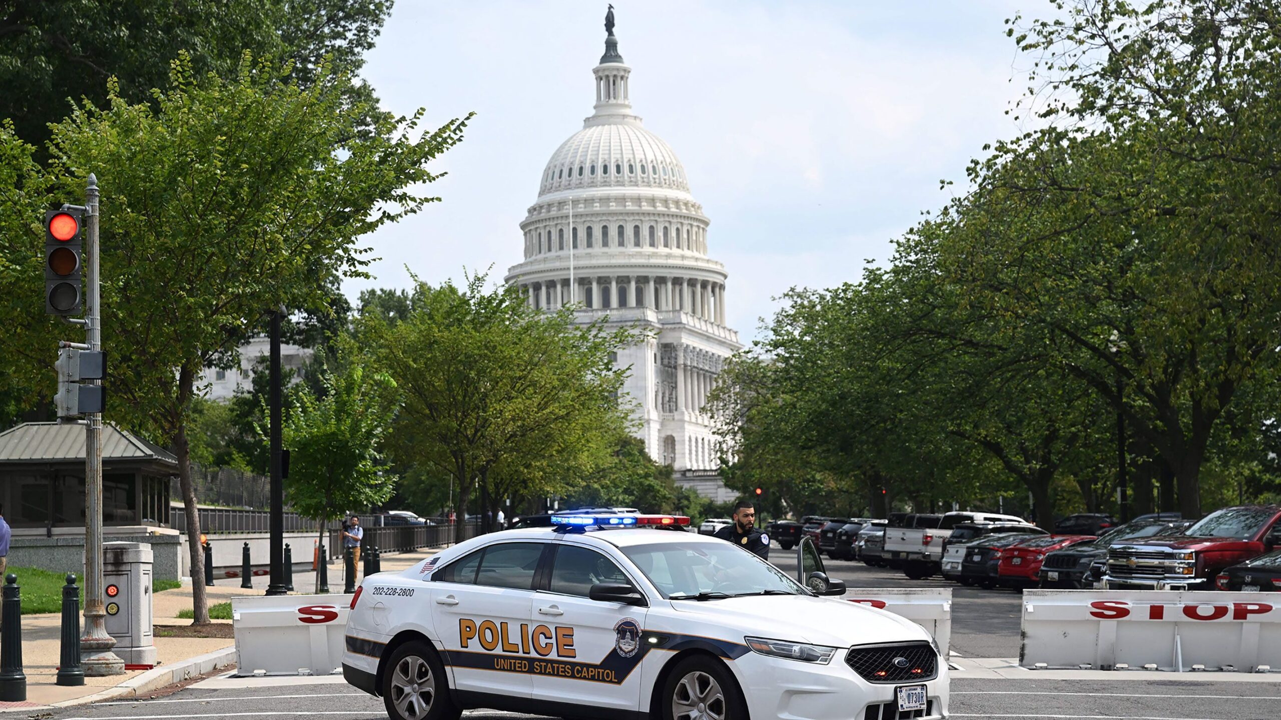 a police car in front of a senate office...