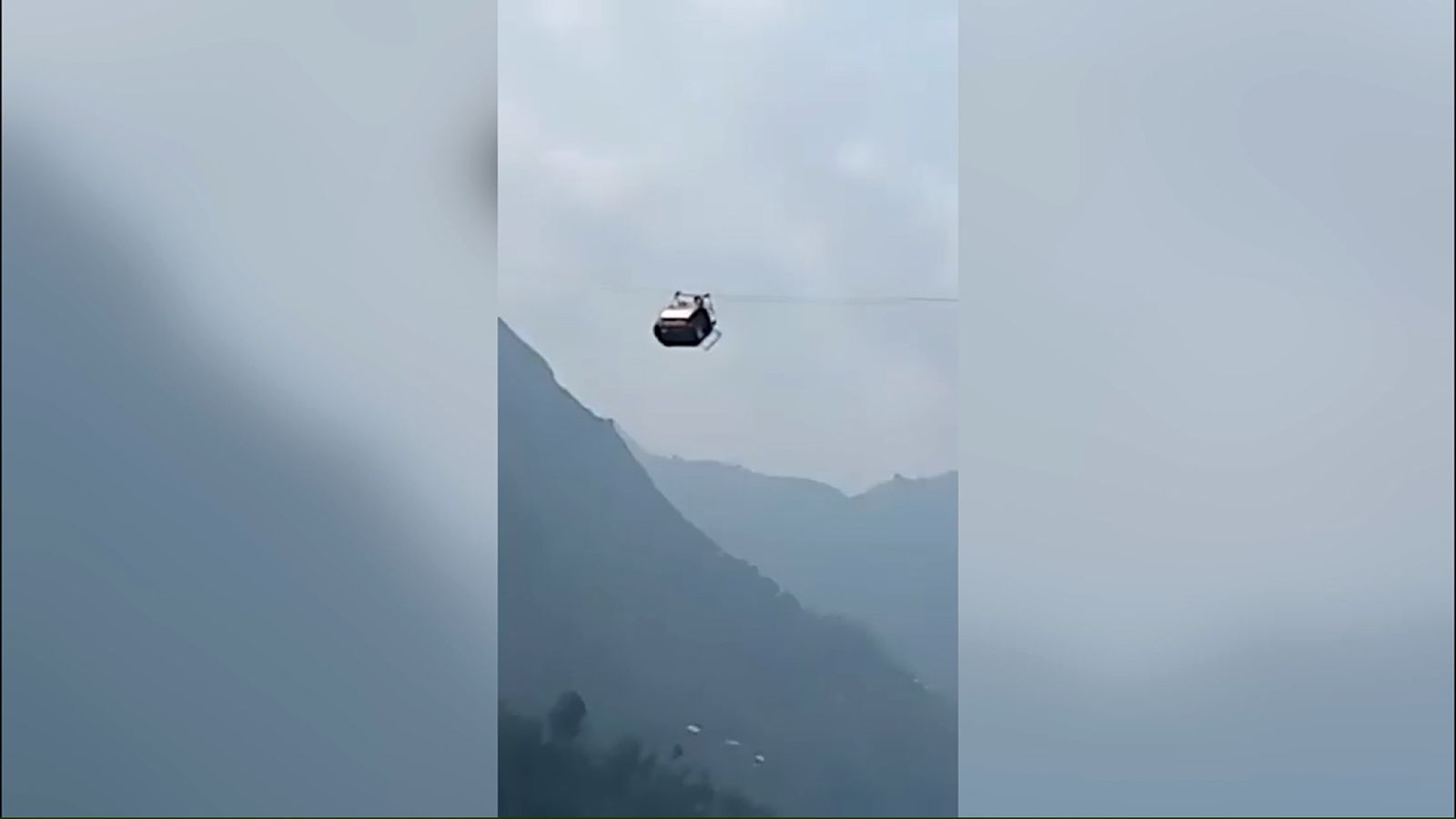 Image of a cable car dangling hundreds of feet over a valley in Pakistan....