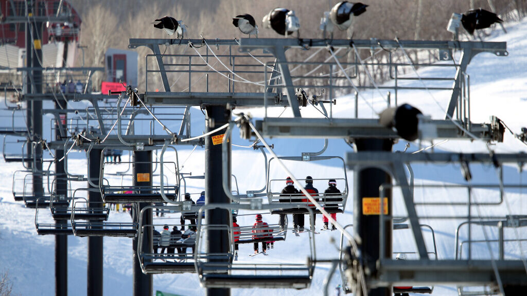 Ski lift chairs travel up the mountain at Park City Ski Resort....