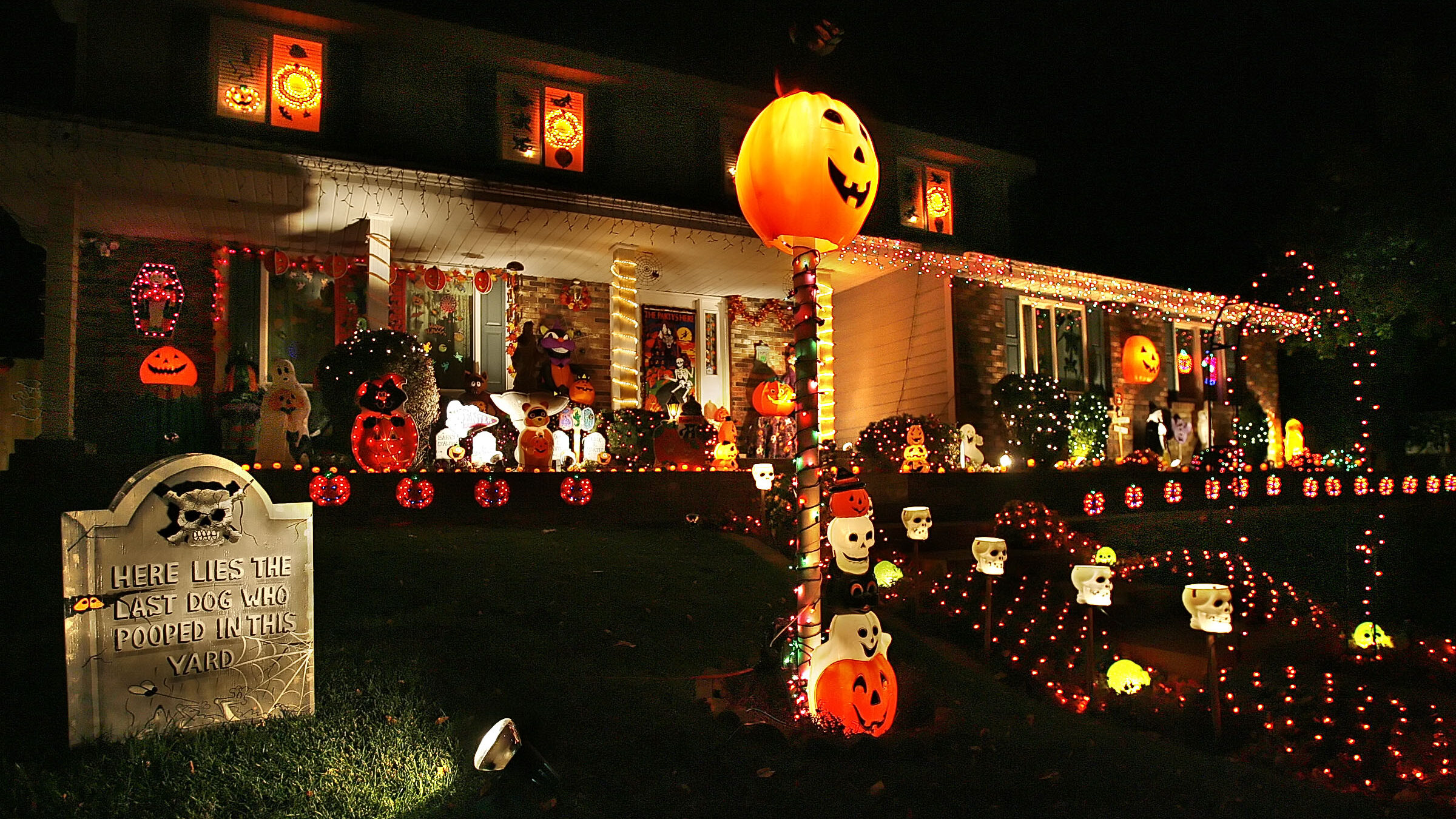 Image of a home decked out for Halloween in Sandy, Utah. Article is about where and how people are ...