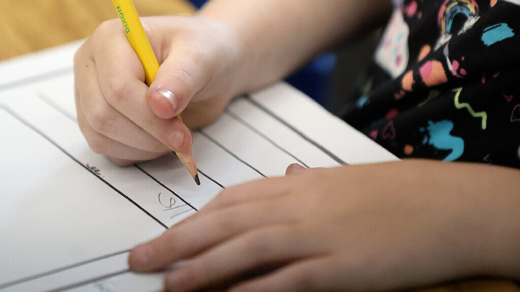 A child completes a worksheet. (Kristin Murphy/Deseret News)...