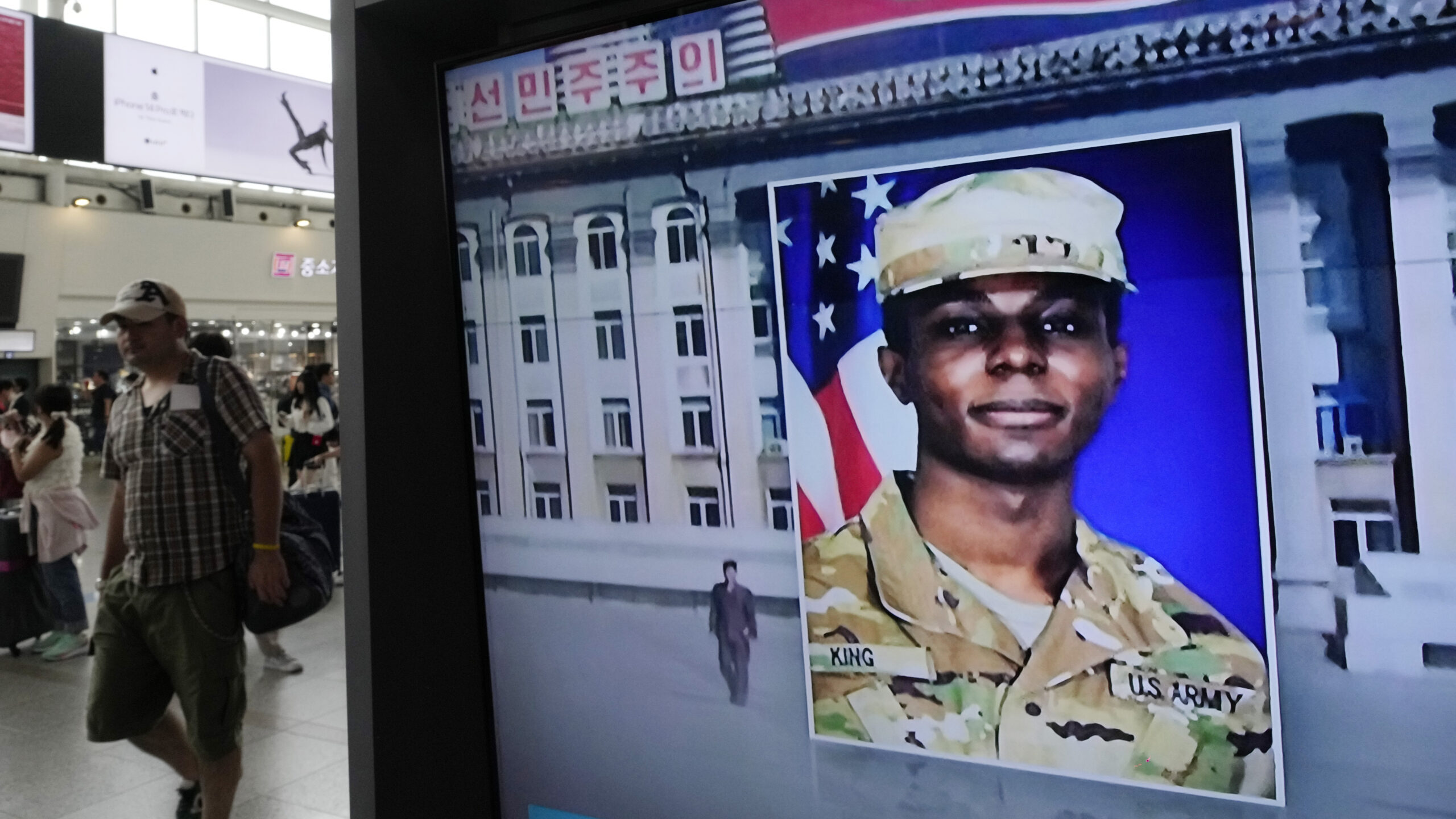 FILE - A TV screen shows a file image of American soldier Travis King during a news program at the ...