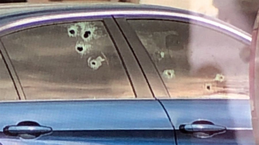 A car riddled with bullet holes in the Farmington U.S. Post Office parking lot after a report of sh...