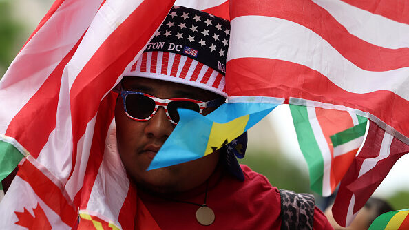 An activist marches during a rally for migrant rights on International Workers Day, May 01, 2023 in...