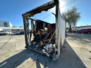 Image of what remains of a box trailer, the site of a fatal fire in Millcreek on Tuesday night.