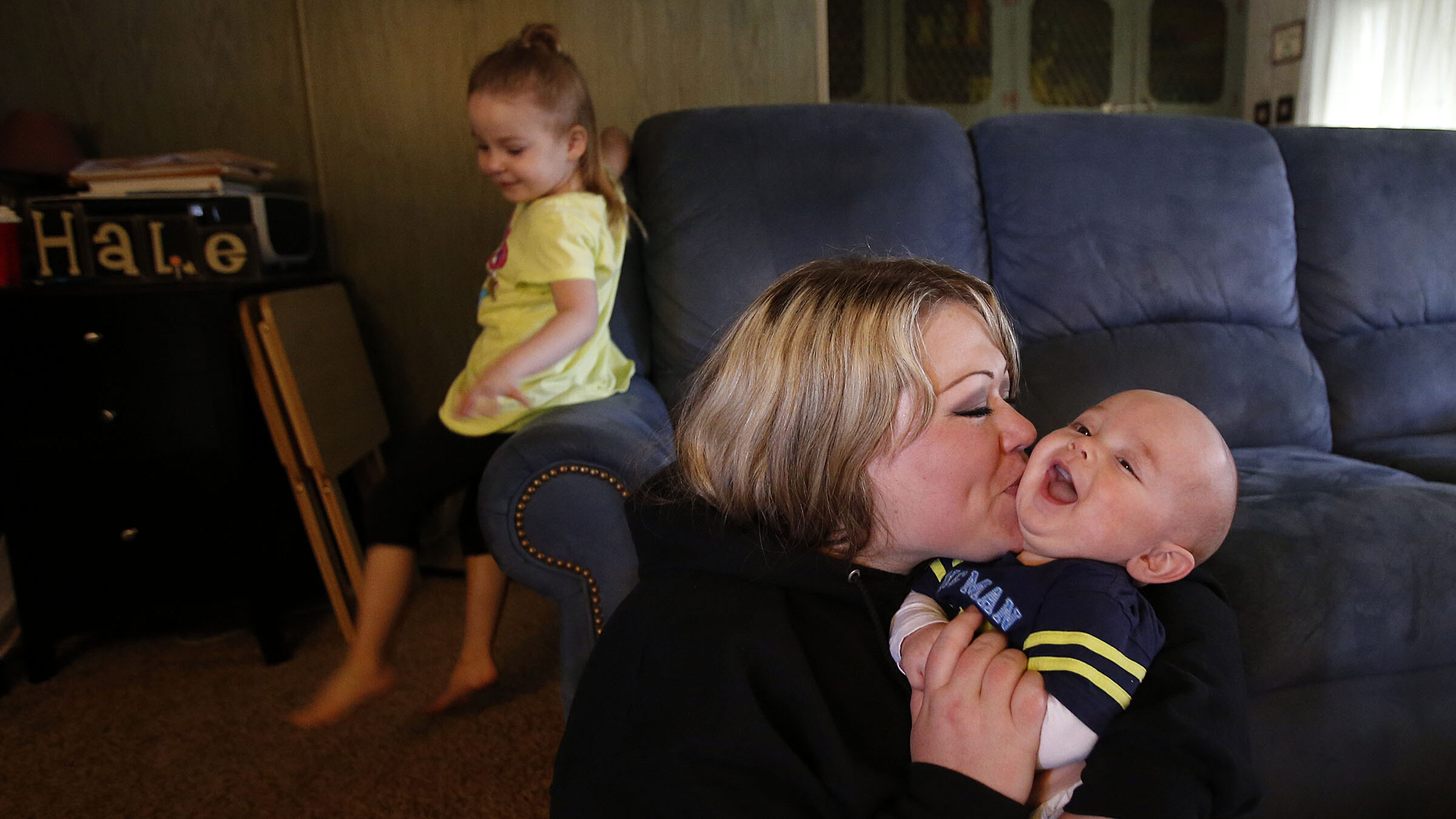 FILE: Stacie Hale plays with her son Theodor at home in Smithfield. Stacie hoped to get aid from WI...