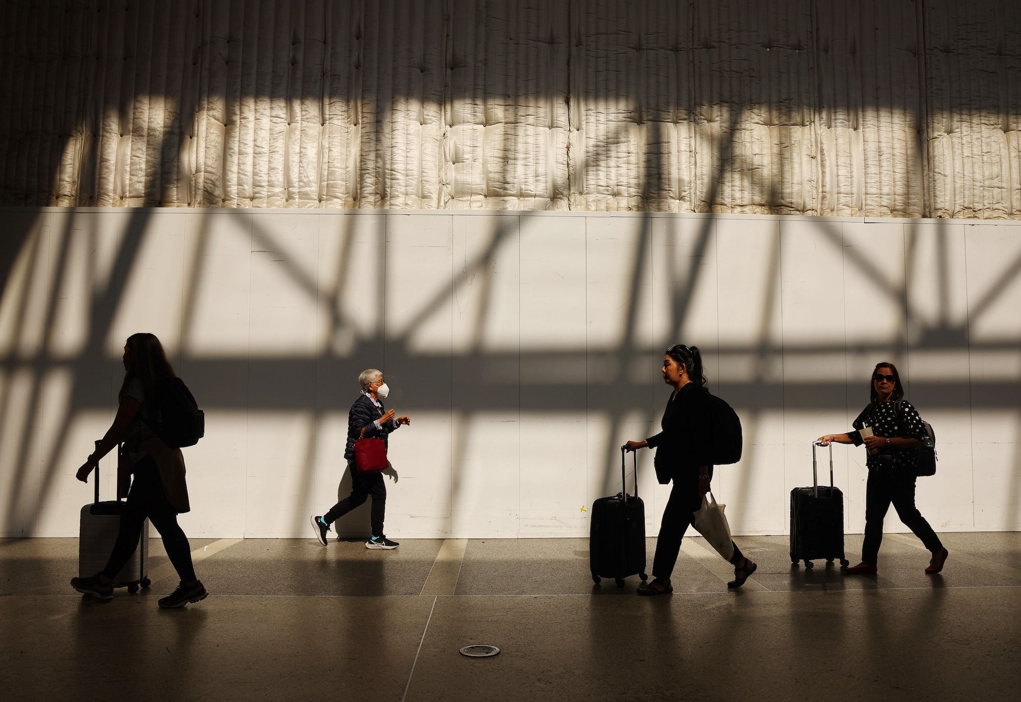 Travelers walk in the international terminal at Los Angeles International Airport (LAX) on August 3...
