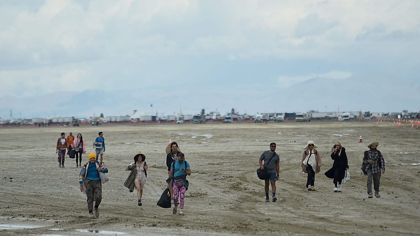 People walk off the playa out near the Burning Man site on the Black Rock Desert in northern Nevada...