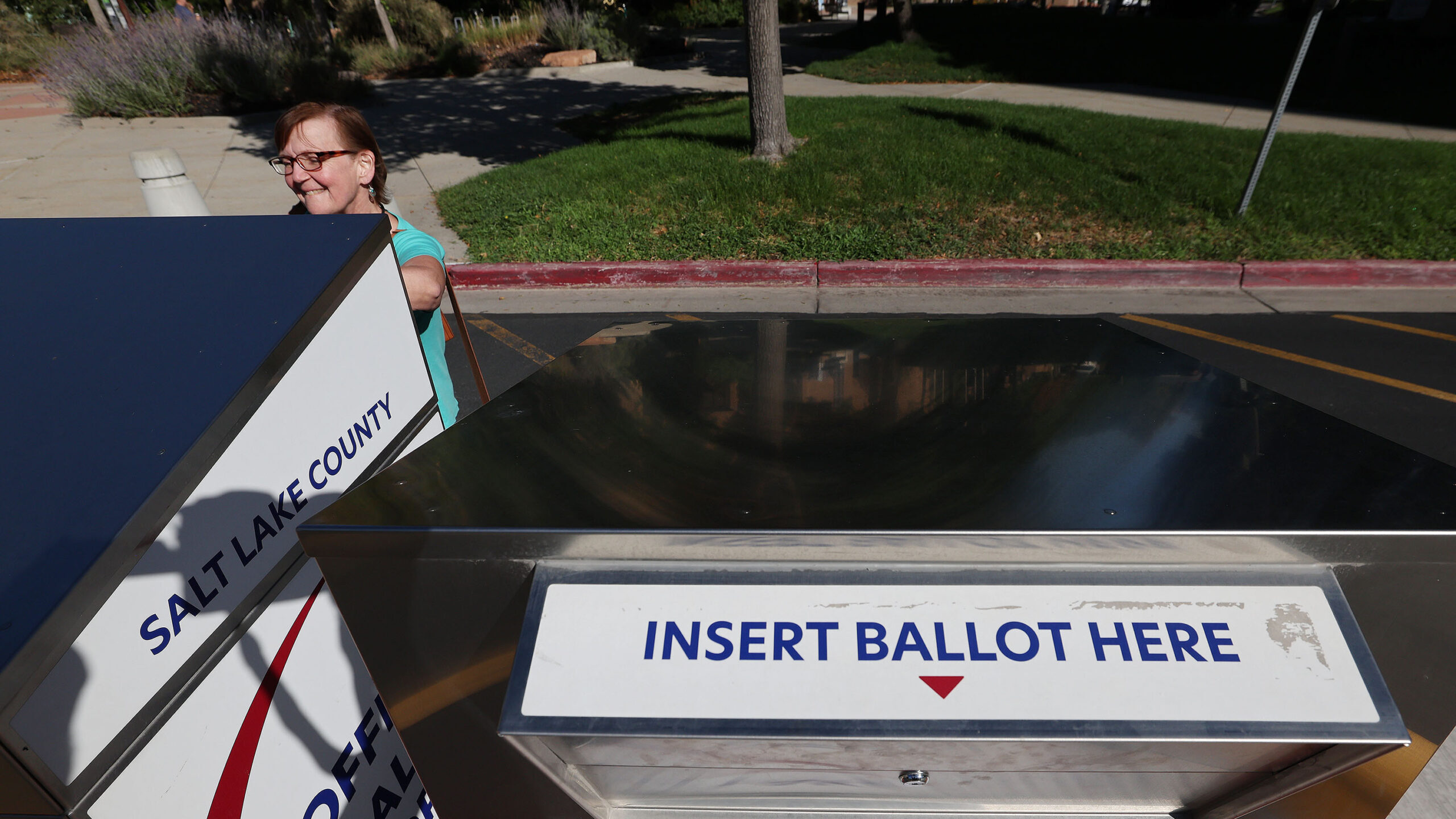 Jona Curry drops off her ballot during Utah's municipal and primary election. Mail-in ballots have ...