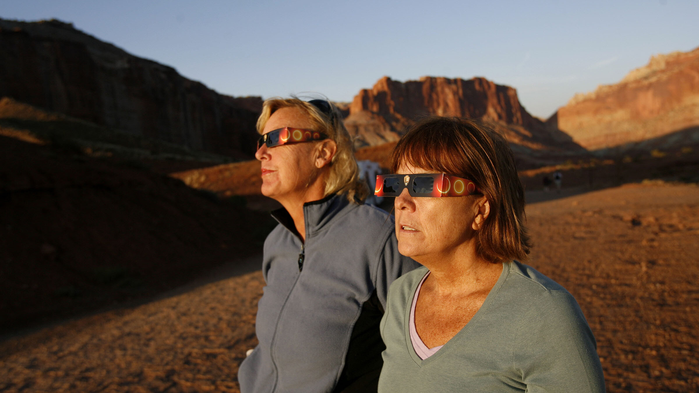 Two people view an annular eclipse from Capitol Reef National Park....