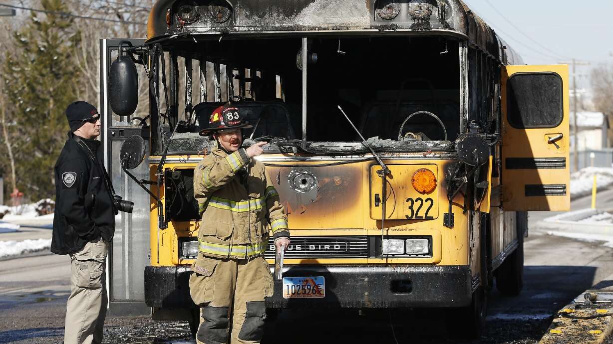 A Granite School District bus is looked over after it caught fire on Jan. 27, 2017. No students wer...
