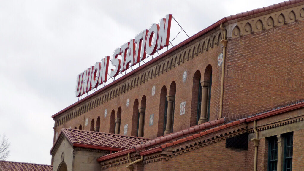 Ogden's Union Station exterior features brown bricks and a neon sign reading "Union Station"...