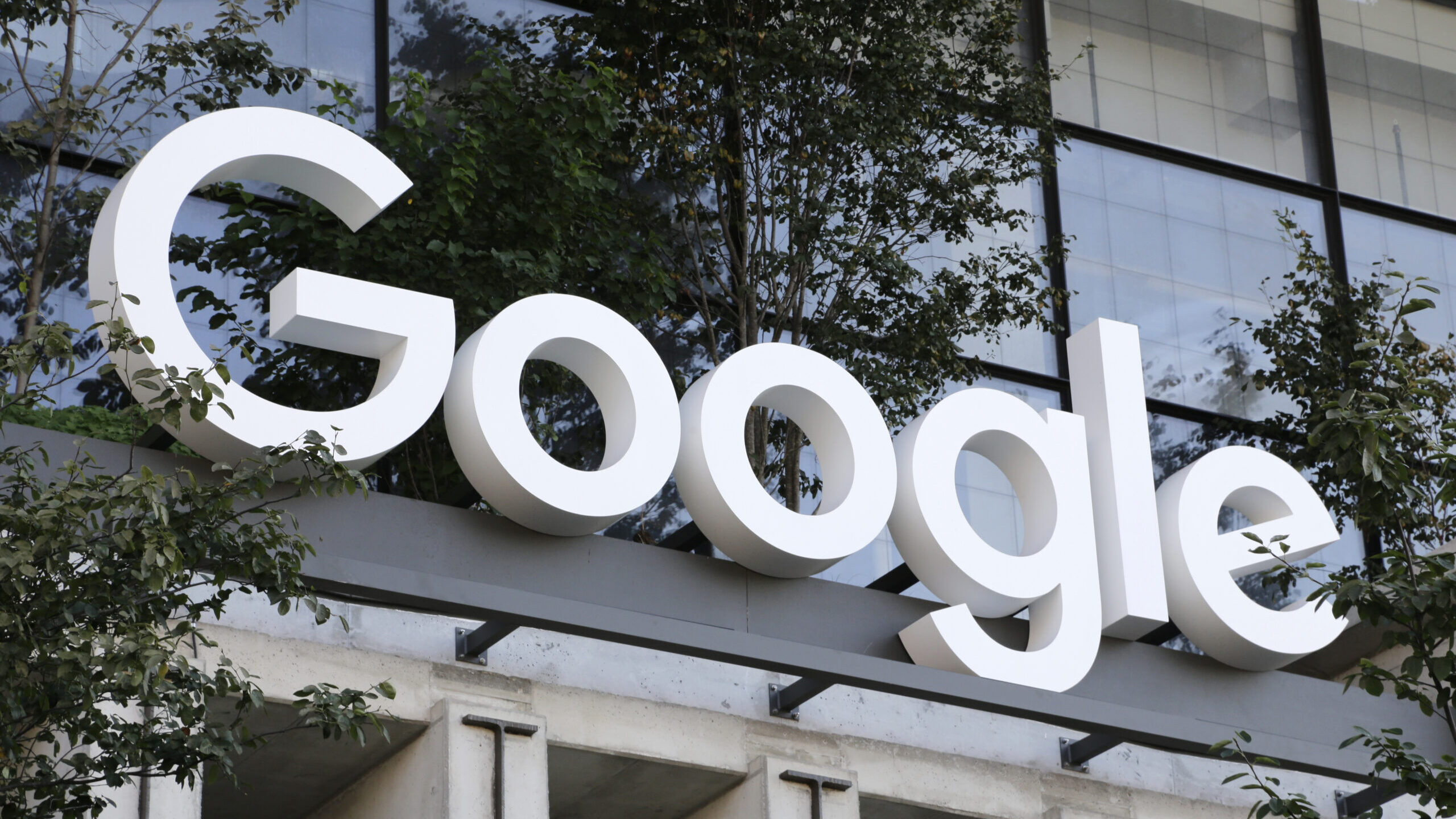 FILE - A Google sign hangs over an entrance to the company's new building, Sept. 6, 2023, in New Yo...