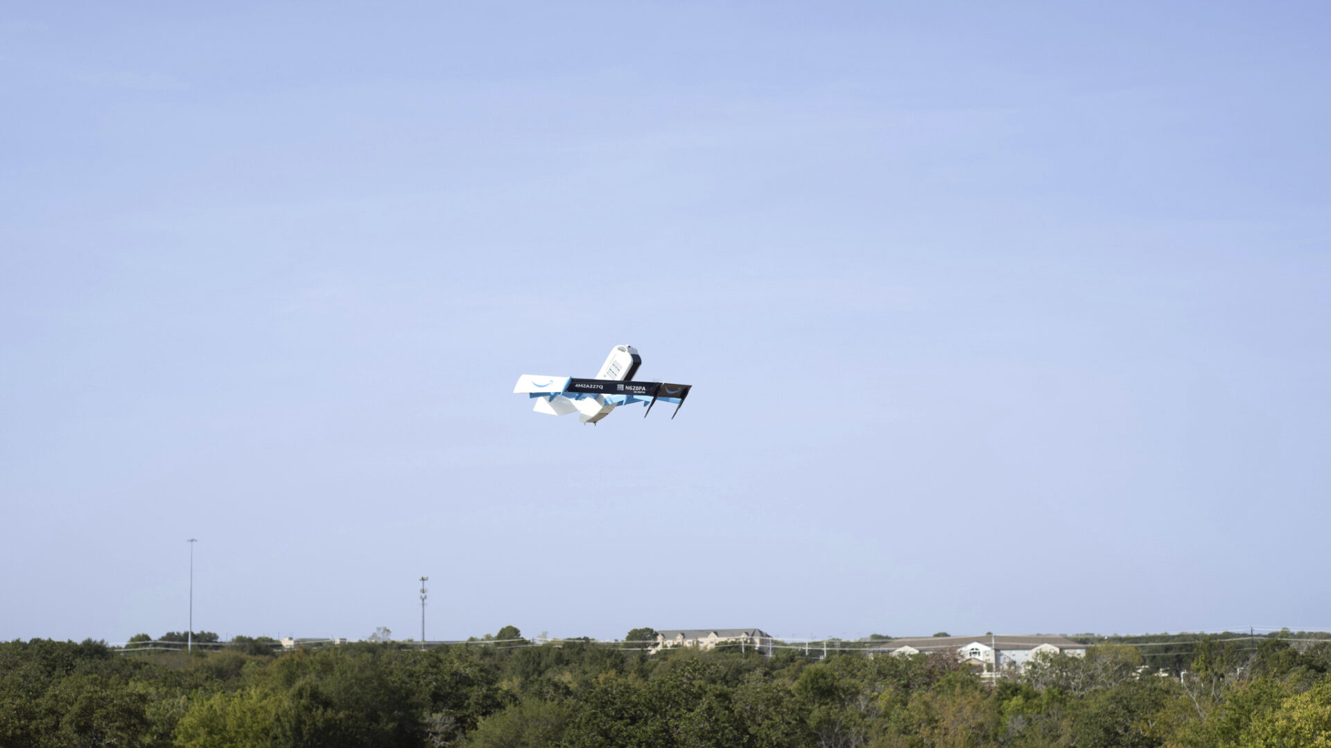 This photo provided by Amazon shows a drone delivering presciption drugs in College Station, Texas....