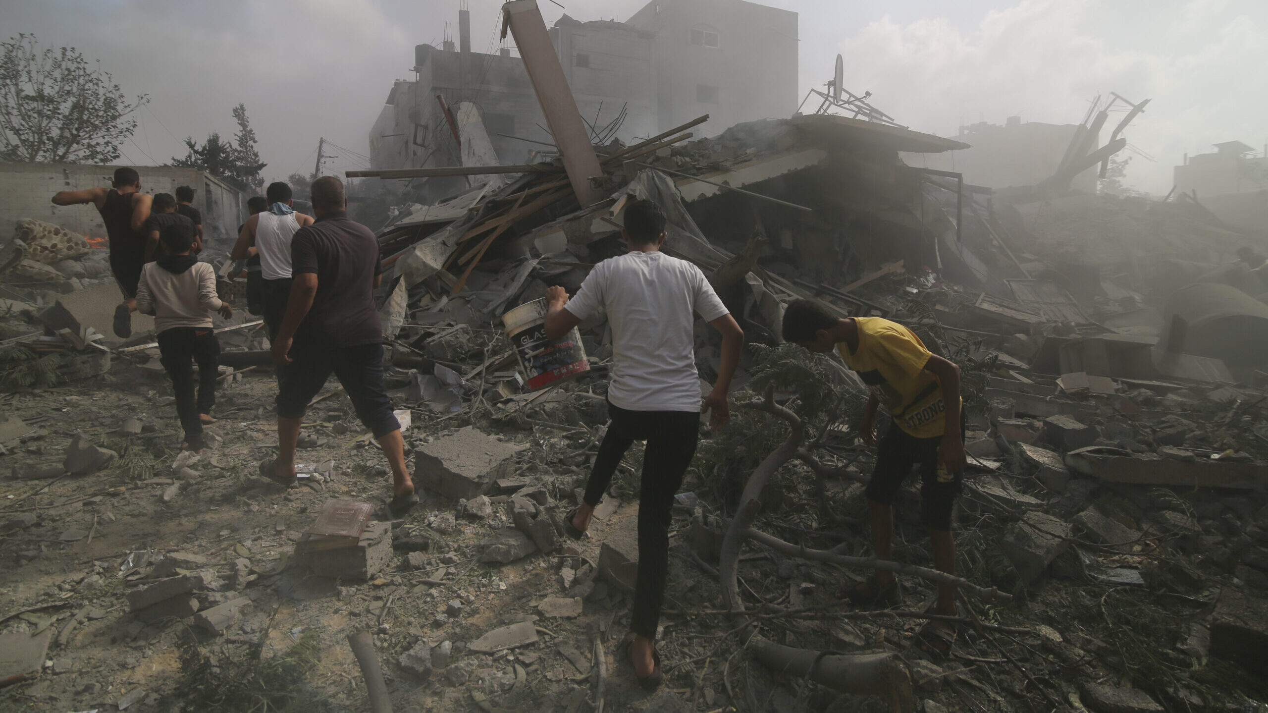 Palestinians look for survivers in buildings destroyed in the Israeli bombardment of the Gaza Strip...