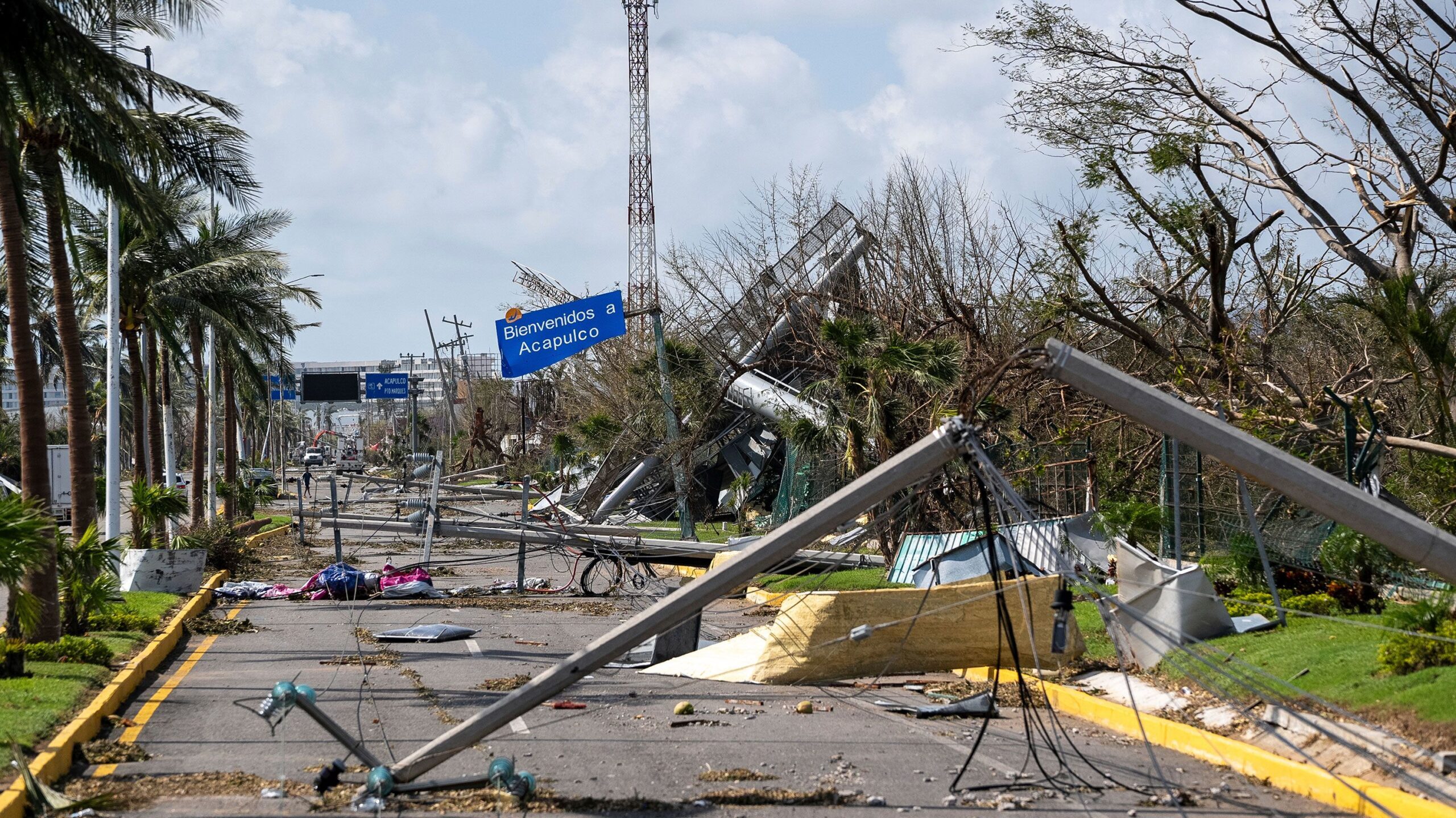 Downed electrical poles and lines blown over by Hurricane Otis blanket a road in Acapulco, Mexico, ...