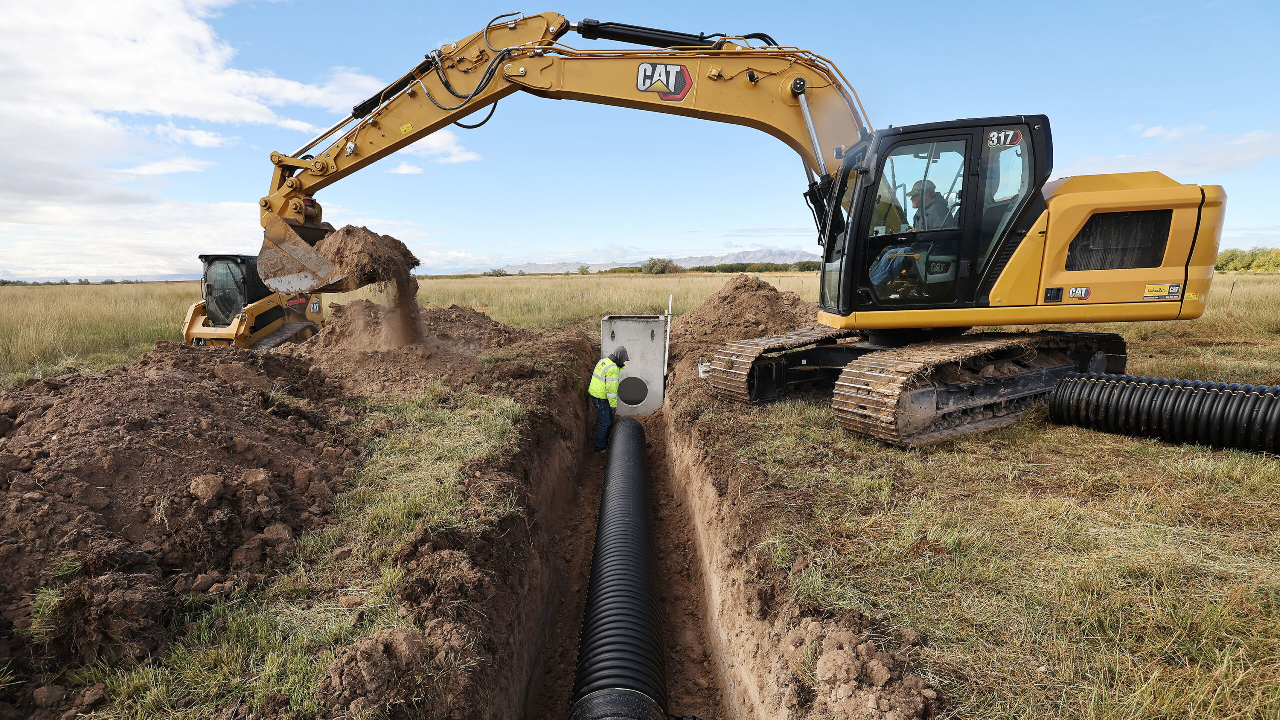Austin Thomas and Travis Call install some of the 3,000 feet of irrigation pipeline to replace ditc...