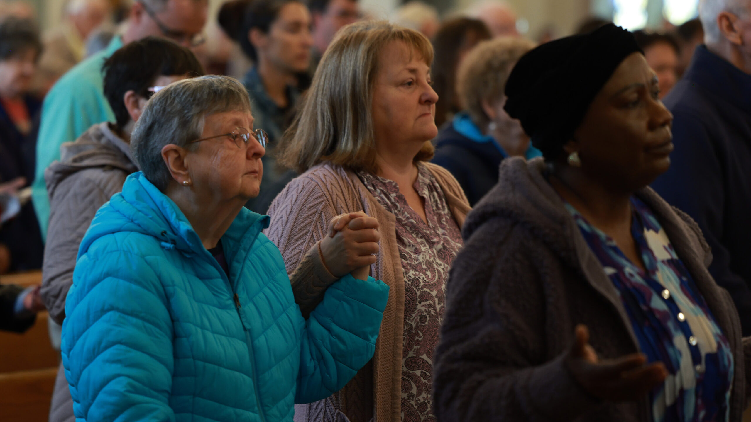 Parishioners pray during the Holy Cross Church service on October 29, 2023 in Lewiston, Maine. Duri...