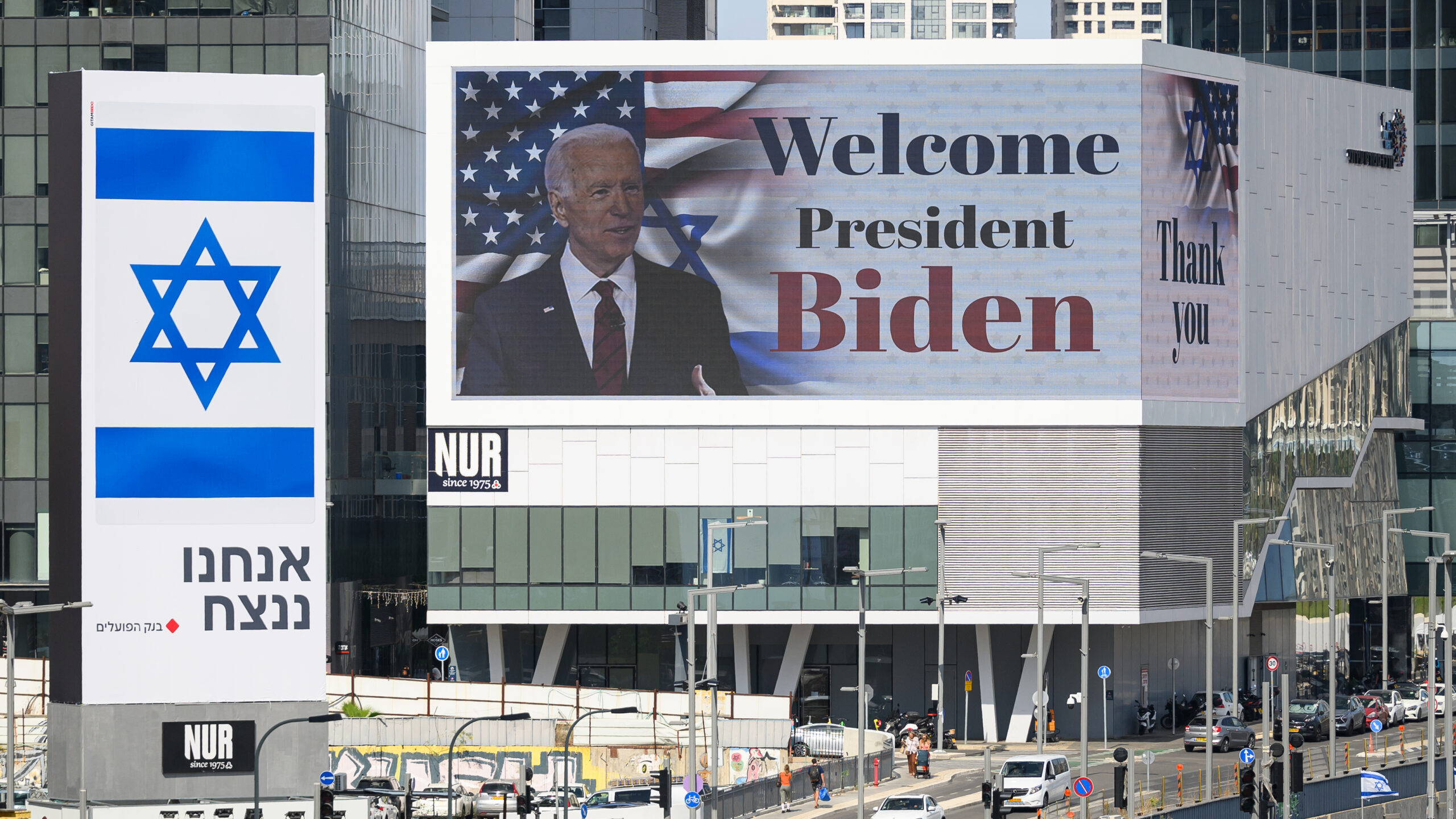 a sign welcomes president biden while he was in israel...