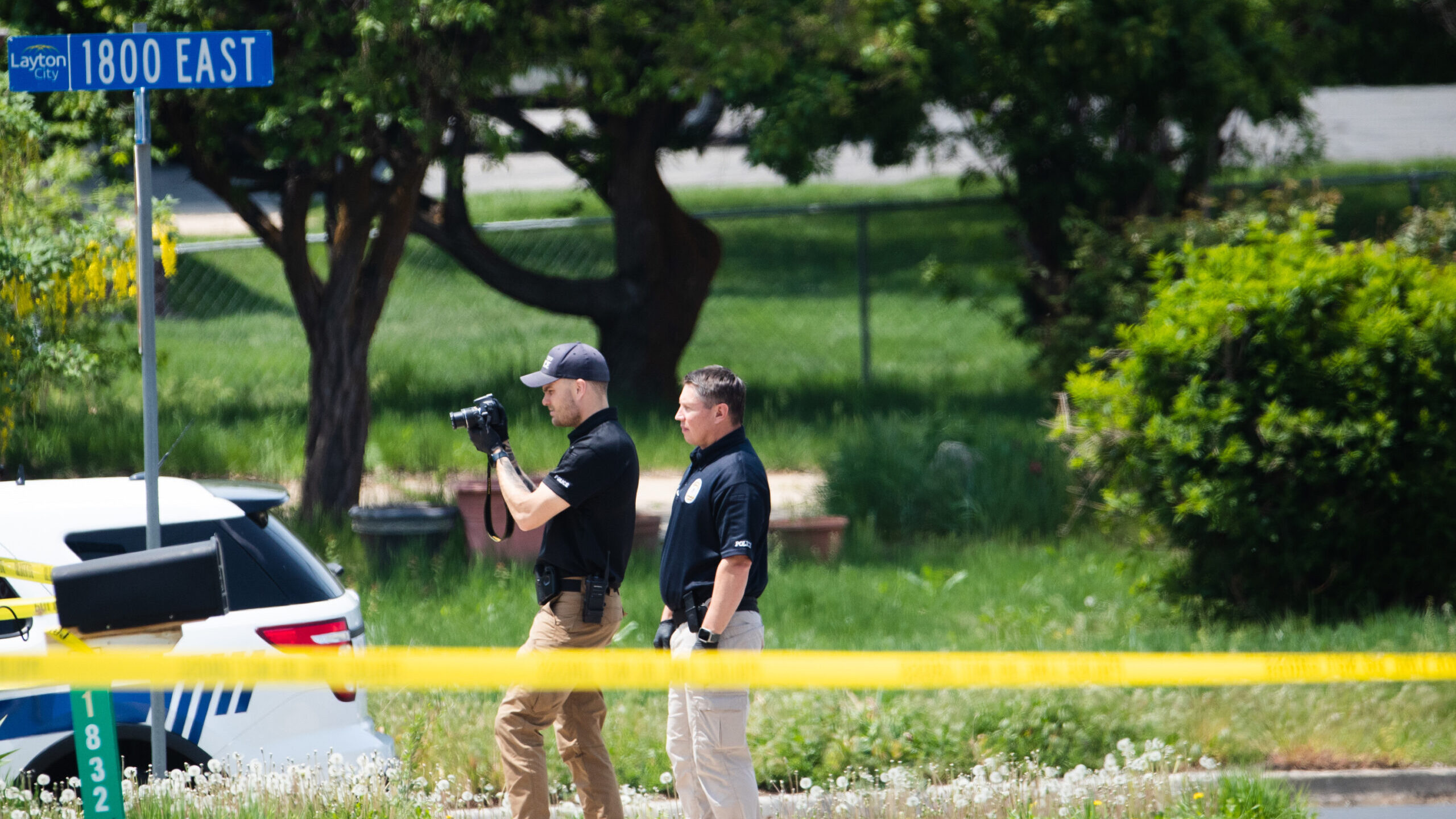 FILE: Layton Police officers photograph a home and yard at the scene of a triple homicide in Layton...