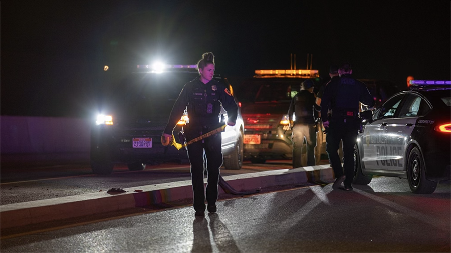 A Salt Lake City, Utah, police officer is putting crime scene tape across Redwood Road near 200 Sou...