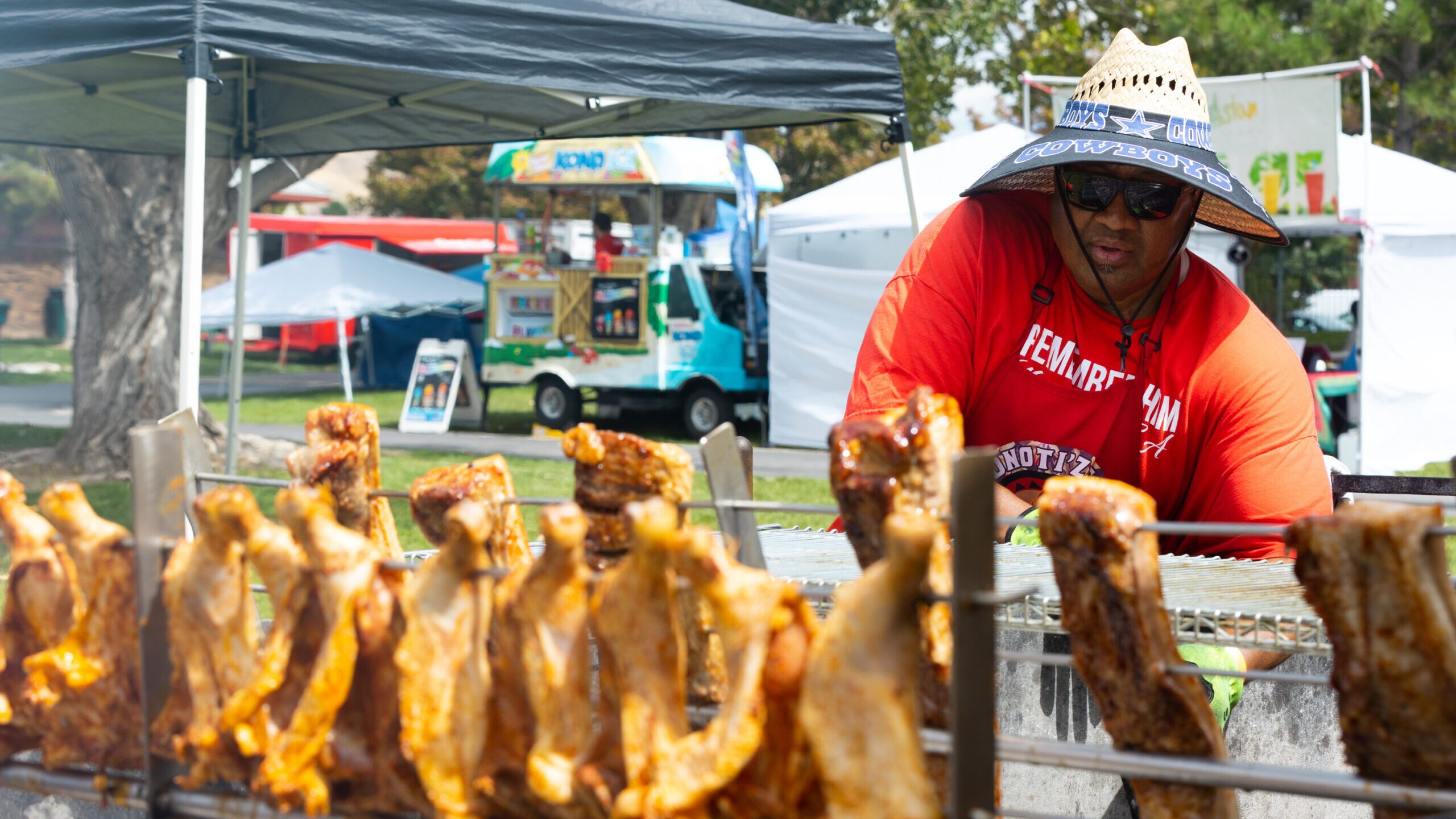 Kiwi Tui tends the coals under the meat at Foniti’z Fix food truck during Polynesian Days Utah at...