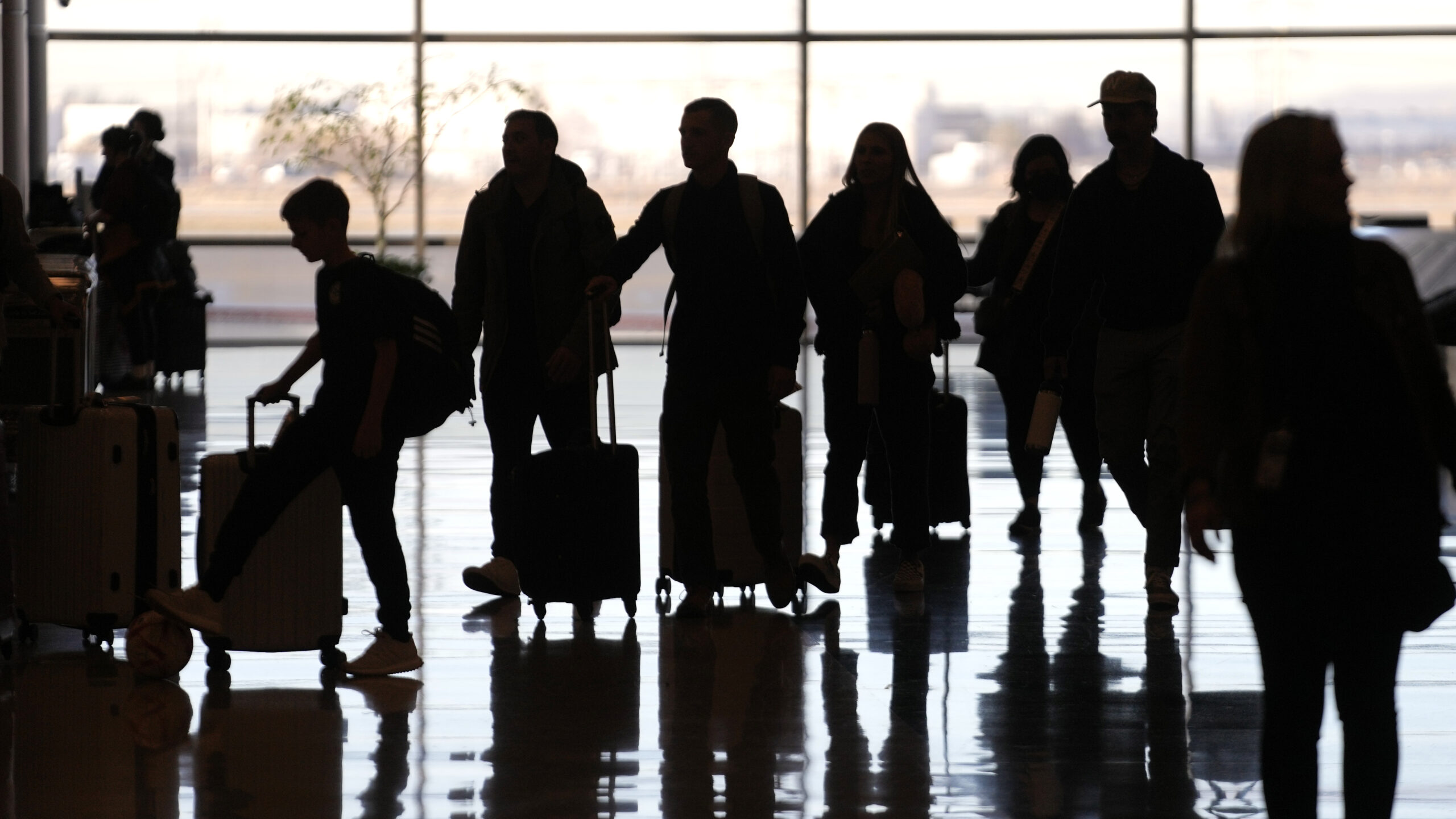 FILE - People pass through Salt Lake City International Airport on Wednesday, Jan. 11, 2023, in Sal...